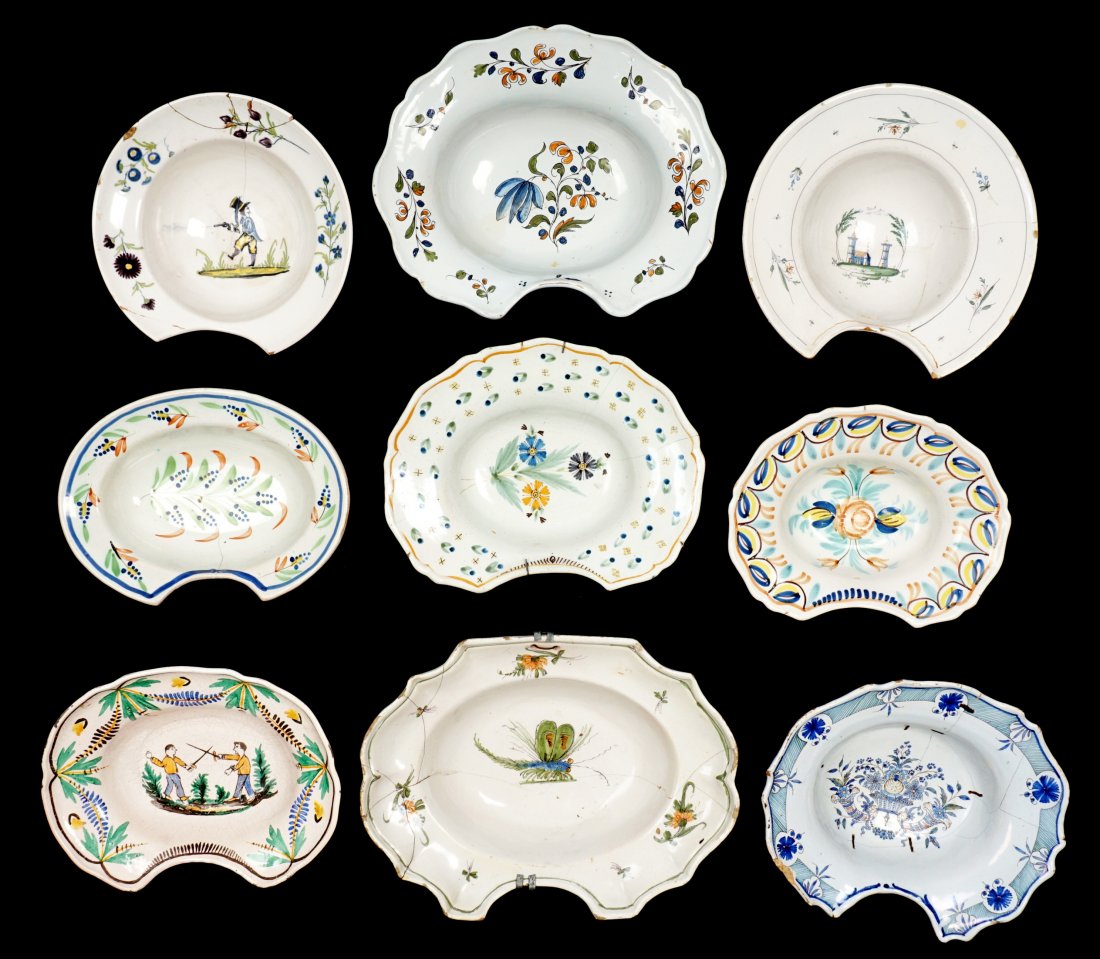 Collection of 9 French Faience Shaving Bowls: An assembled collection of nine 18th / 19th Century shaving bowls, largest 3.25" h. x 14.5". Condition: Chips, cracks, and repairs to be expected.