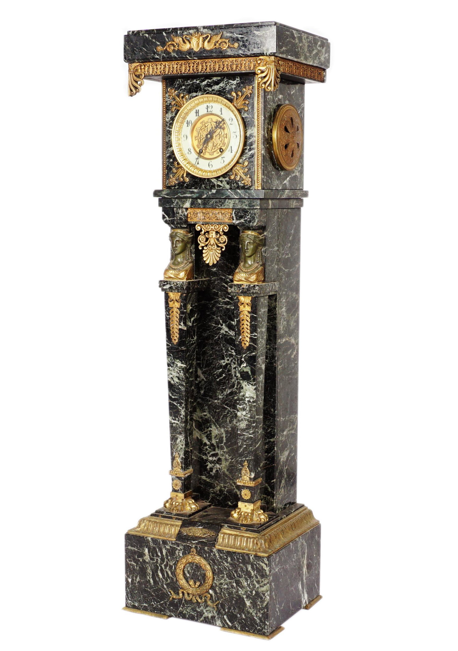 Guillemet French Marble & Bronze Dore Pedestal Clock: Stunning floor clock, variegated dark green marble case, applied gilt bronze accents, two tapered full column supports with busts at top. Porcelain chapter ring, Arabic numerals, center pieced accents