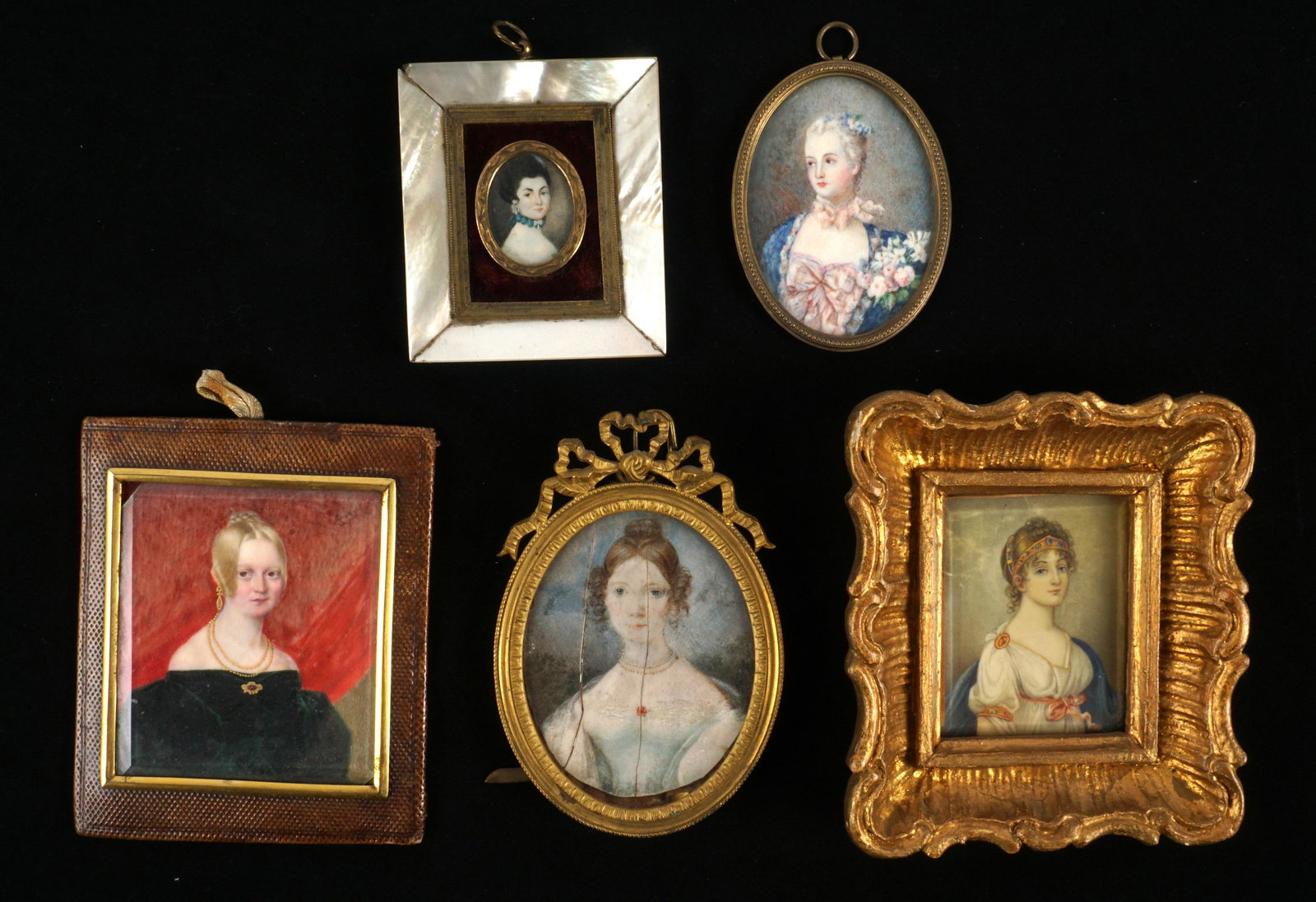 Five Continental Portrait Miniatures: An assembled collection of five pieces total to include 1) Mid 19th C. young girl in green velvet gown, gold jewelry, red drape background, brass bezel and punched leather frame, green felt back, 4.5"