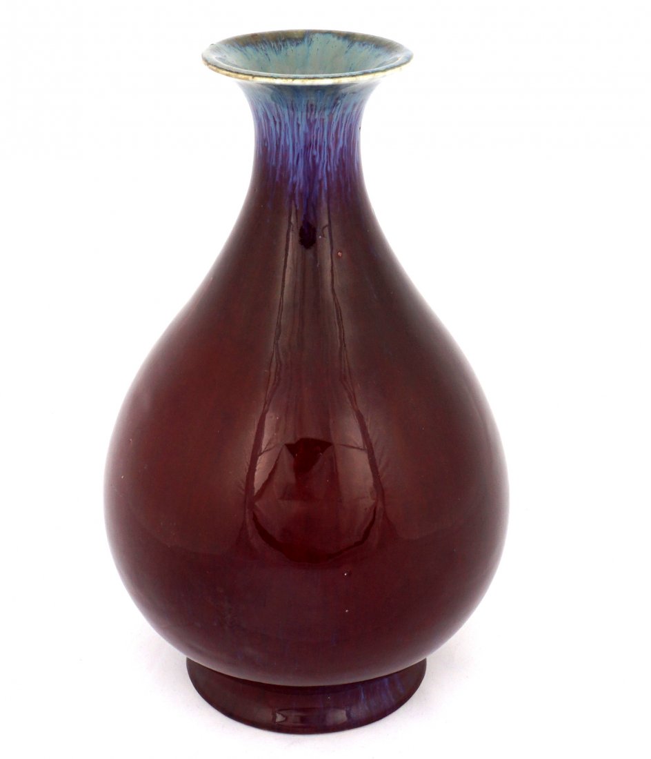 Chinese Yuhuchunping Flambe Vase: Large vase in the yuhuchunping form, blue graduating to pigeon blood red flambe glaze, bears an impressed Qianlong mark on base. 12" h. x 7.5".