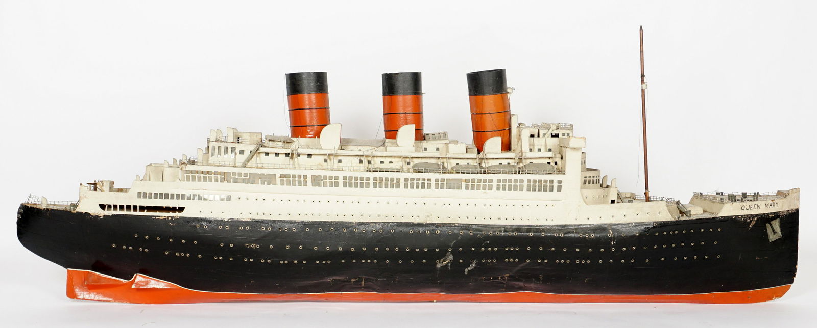 Large Queen Mary Hand Crafted Cruise Ship Model: Hand crafted with assorted soft woods, paper mache, and metal wire. Overall measures 34" h. x 74" x 12". Condition: Breaks, splits, and loss, sold with all faults.