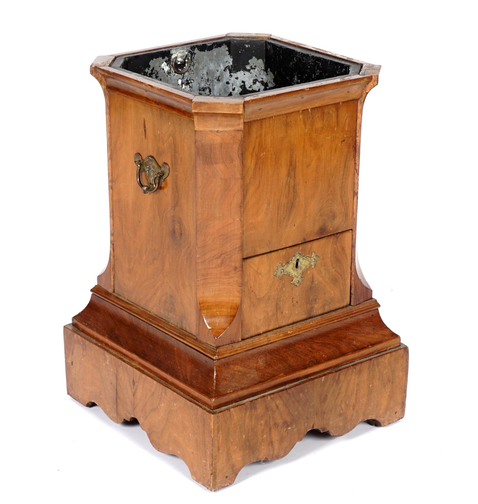 Georgian Rosewood Planter: Rosewood stepped case, top with canted corners, single drawer, base with scroll apron, applied handles, metal insert, overall 19.5" x 13.5" x 13.5". Condition: Veneer chips, splits, and repairs.