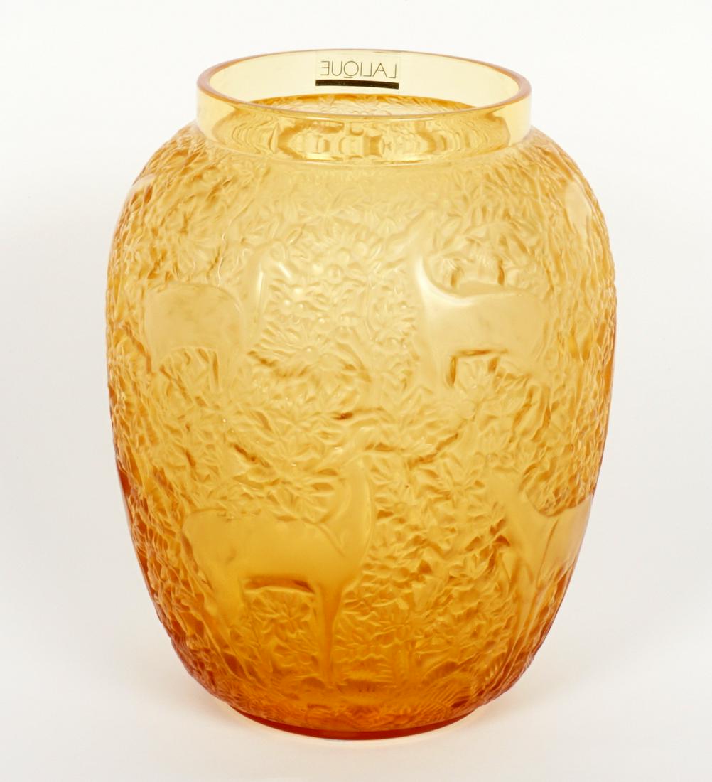 Lalique Birches Amber Crystal Vase: Molded amber glass in the "Birches" pattern by Lalique featuring deer and foliate design, signed on base, 7" h. x 5.5".