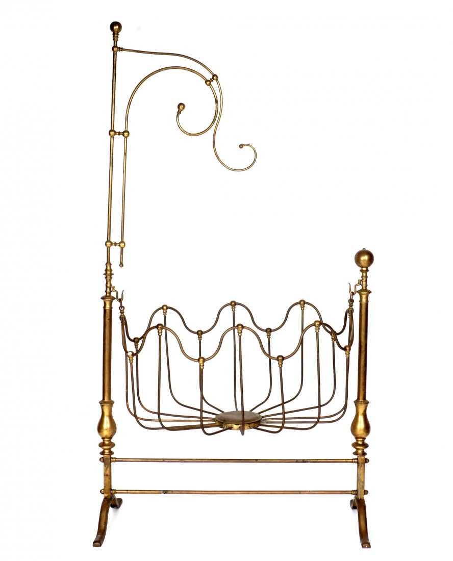 Antique Victorian Brass Cradle: Late 19th Century, brass tube construction. Upper canopy hook over scalloped rocking bayonet, 2 pilaster supports, splayed feet. Overall 84" h. x 48" x 24". Condition: Uneven patina to brass.
