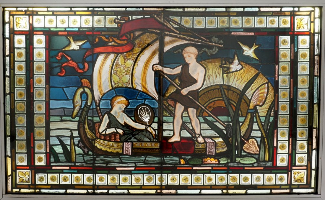 19th Century Egyptian Revival Leaded Glass Window: 19th Century Egyptian revival scene of a man rowing a swan neck felucca boat with seated woman holding a fan, sunset and birds in background, bordered with geometric designs. Sight size 32.75" x 55".