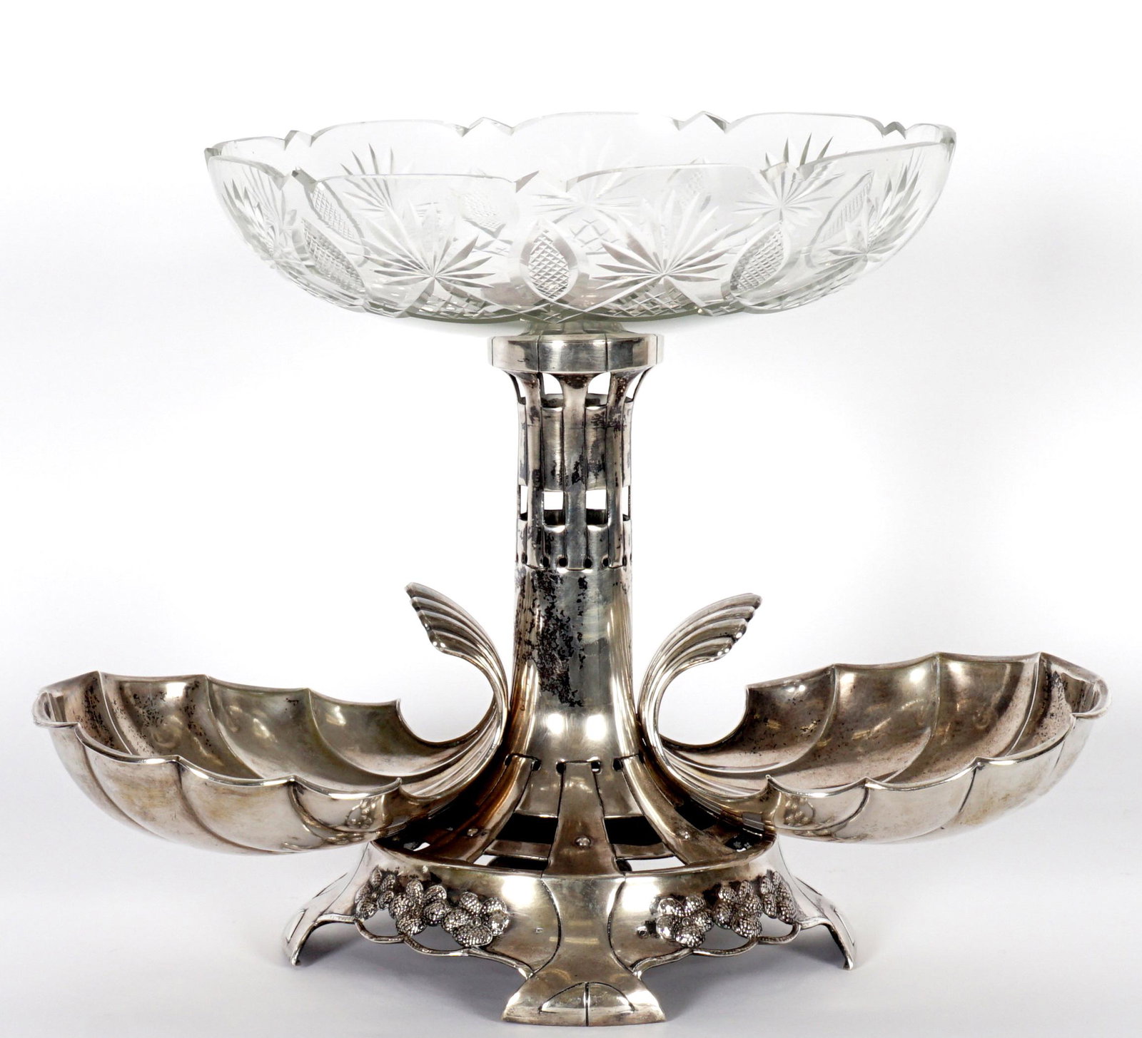 Austrian Silver Epergne Center Piece: Unique openwork base with double shell bowls, embossed floral decoration, large cut glass bowl top, all on four feet. hallmarked on shell, overall assembled 13" h. x 17.5" x 9.5". Approx. 35.8 troy oz