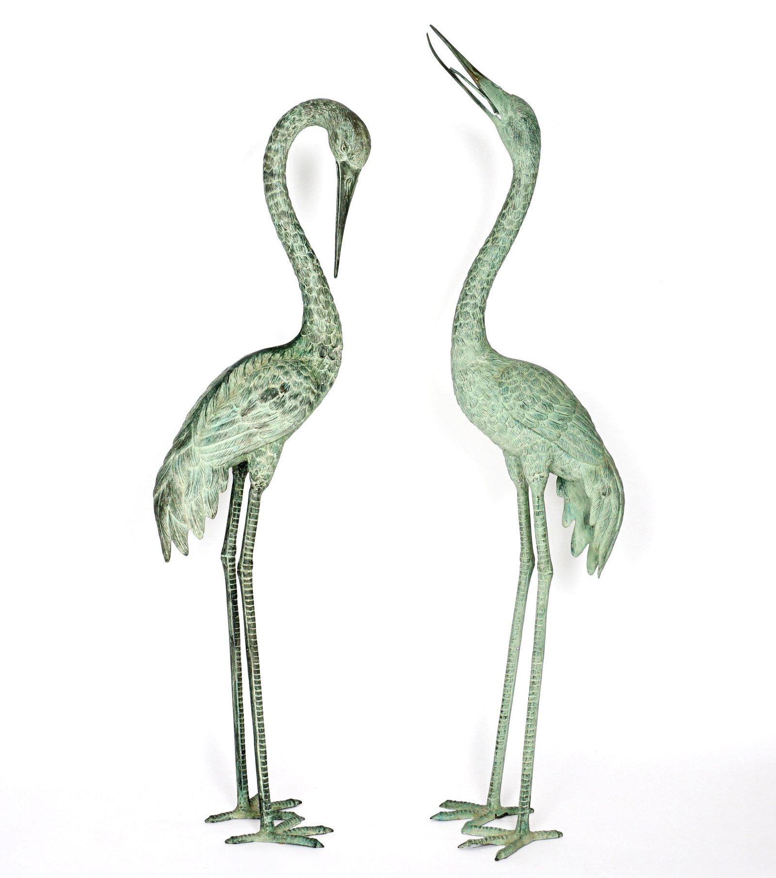 Pair Large Patinated Bronze Cranes: 20th century, patinated bronze figures of cranes, one with head up and one down, overall 70" h. x 9" x 20".