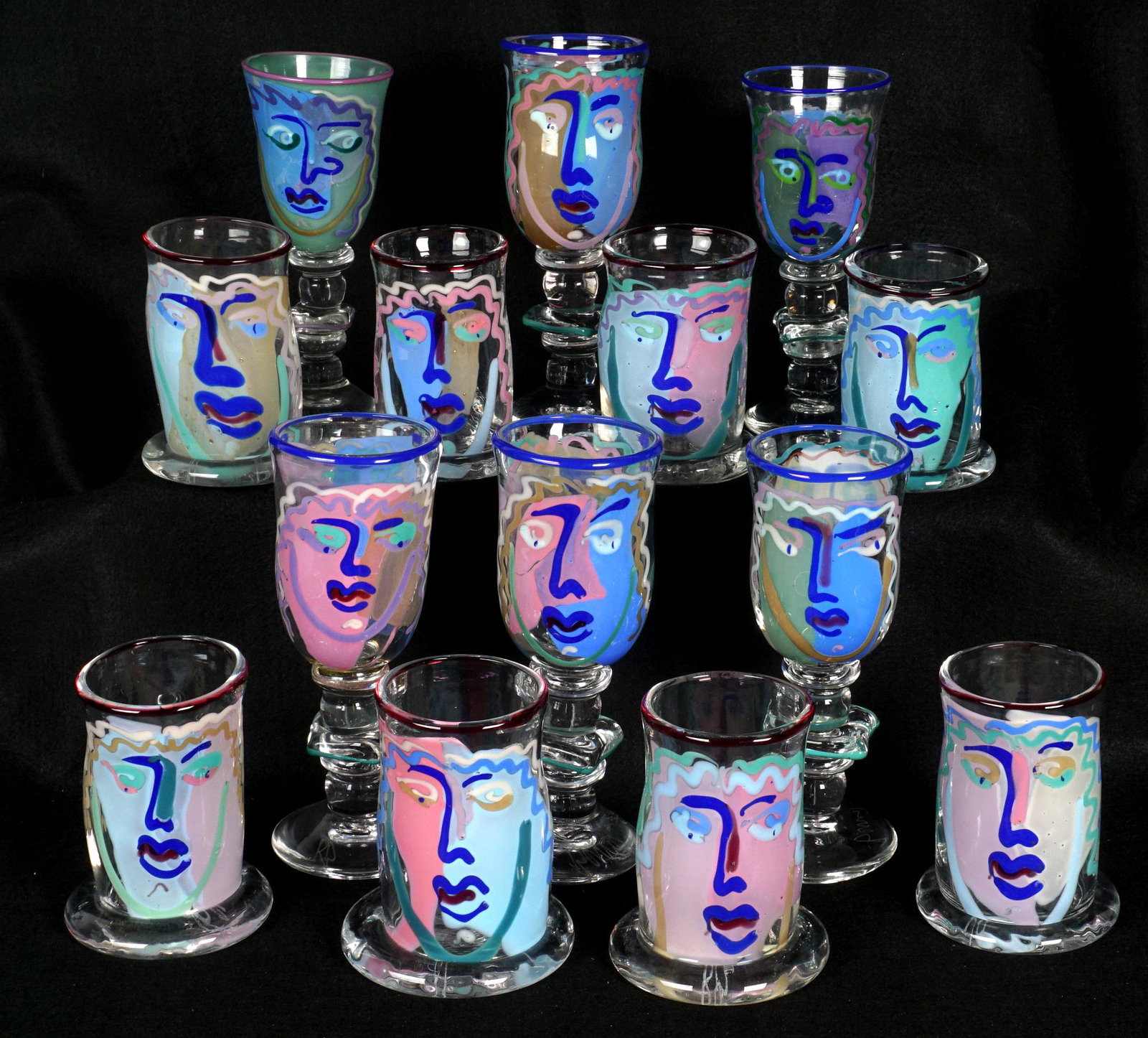 14 K & B Bernstein Art Glass Table Glasses: An assembled collection of 14 pieces total by noted glass artists Kathleen and William Bernstein, each with depiction of a Picasso style woman's face. To include eight tumblers or water glasses, simil