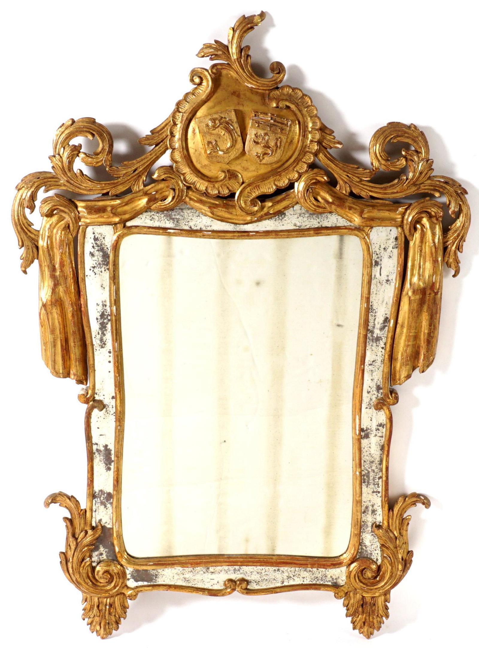 19th Century French Carved Gilt Wood Mirror: Foliate scroll and drapery carved gilt wood frame, crest with shields featuring a dolphin and the other a lion, rectangular center mirror bordered with mirrored panels, overall 50.75" h. x 35.5" x 3".