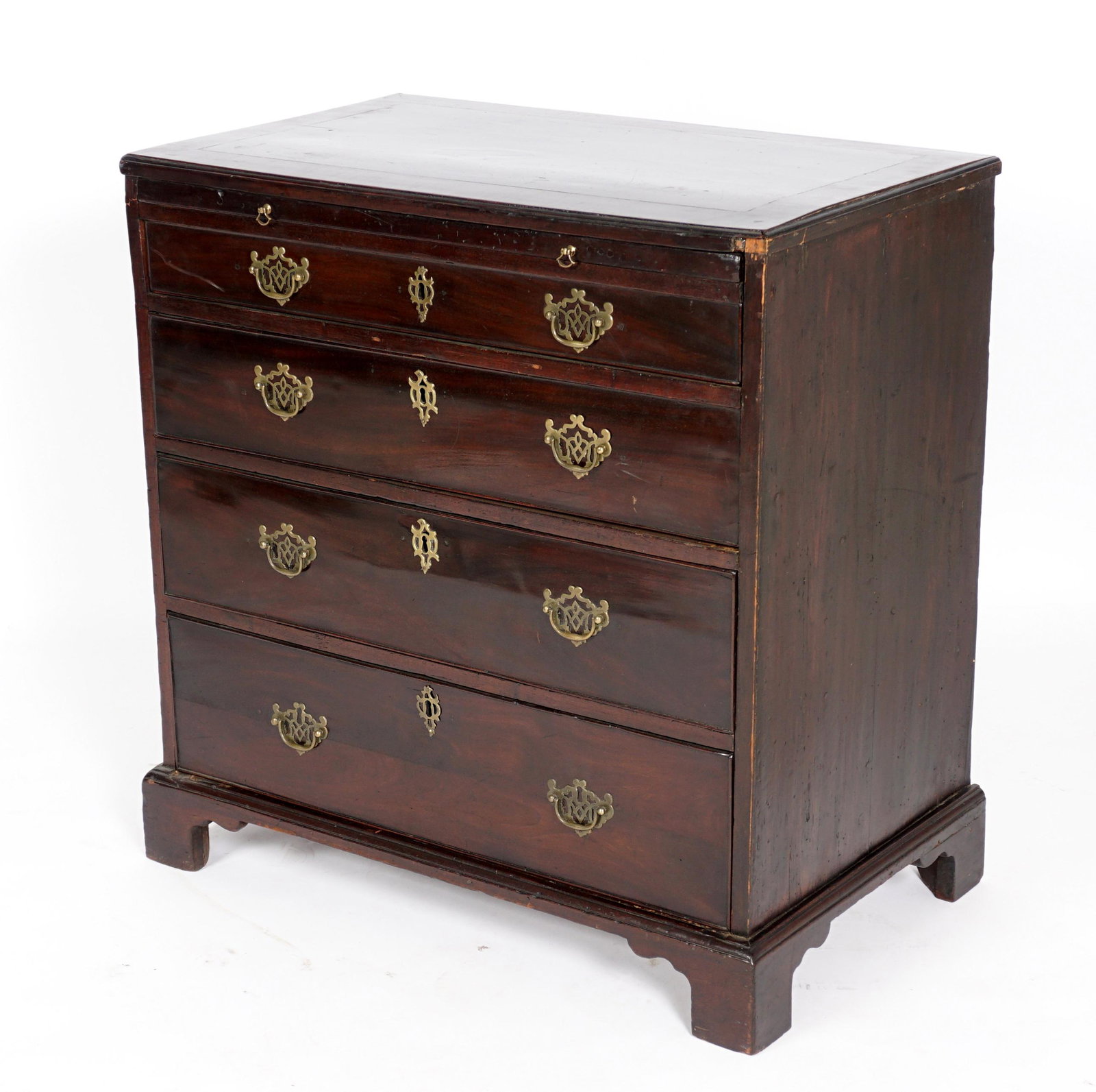 Early 19th C. Mahogany Gentleman's Chest of Drawers: Mahogany case, slide out shelf over four graduated drawers, brass pull, on four bracket feet. 31" h. x 30.75" x 18.25". Condition: Scratches, dings, and abrasions.