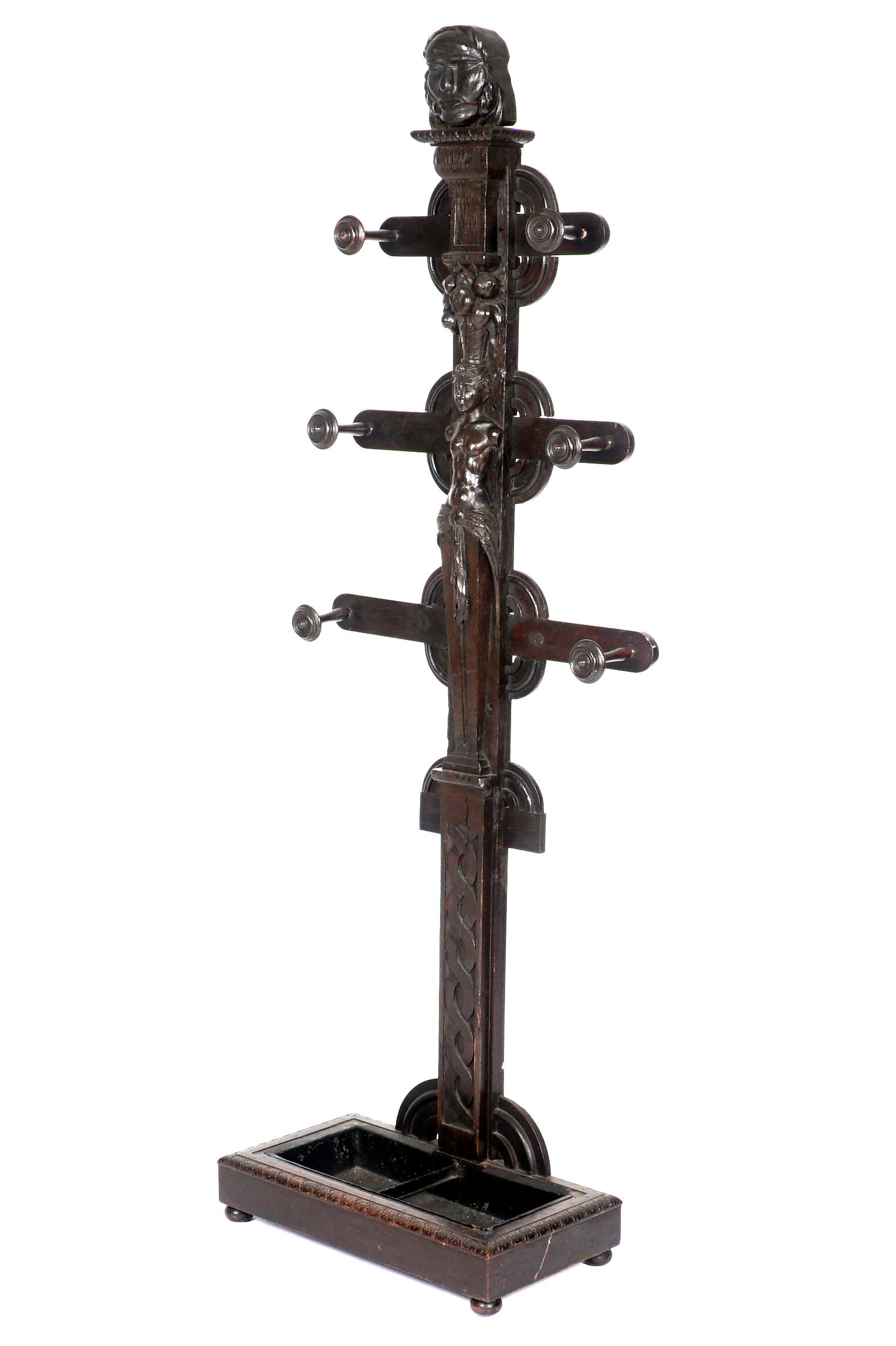 European Figural Carved Hall Tree: Carved bust finial over six arms, center post with carved figure of a semi-nude maiden with basket of fruit on her head, lower twist design. Rectangular base with metal insert, all on four feet. Overa