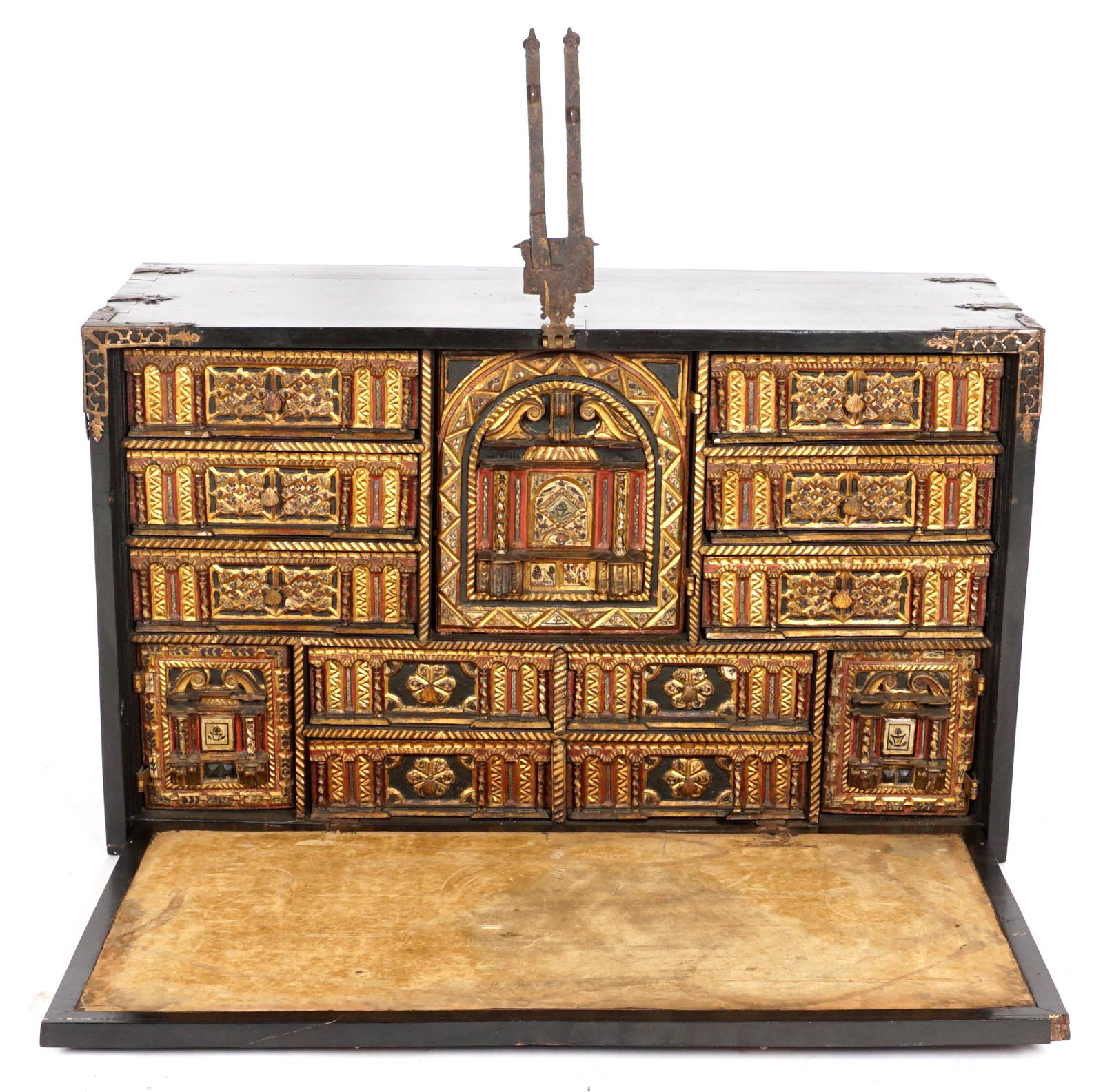 17th/18th Century Spanish Vargueno: Ebonized cabinet with iron handles, hardware, and decoration. Ornately decorated and carved fitted interior, central prospect door opens to reveal 6 drawers, surmounted by ten drawers and two addition