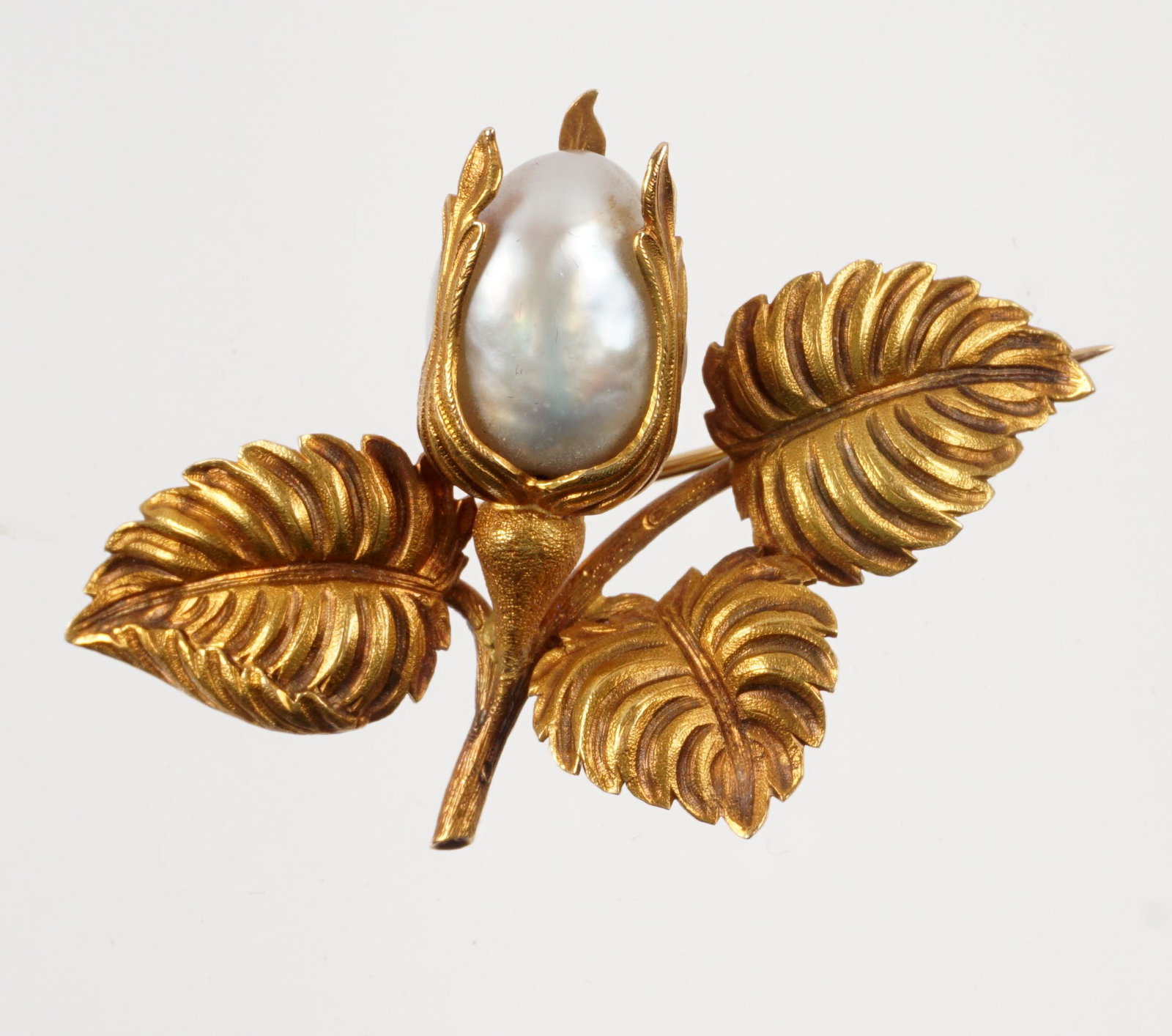 French 18k Gold and Natural Pearl Brooch: Floriform 18k gold pin / brooch, large oblong natural pearl approx. 19mm x 10mm., overall 1.25" x 2". Approx. 9 grams inclusive.