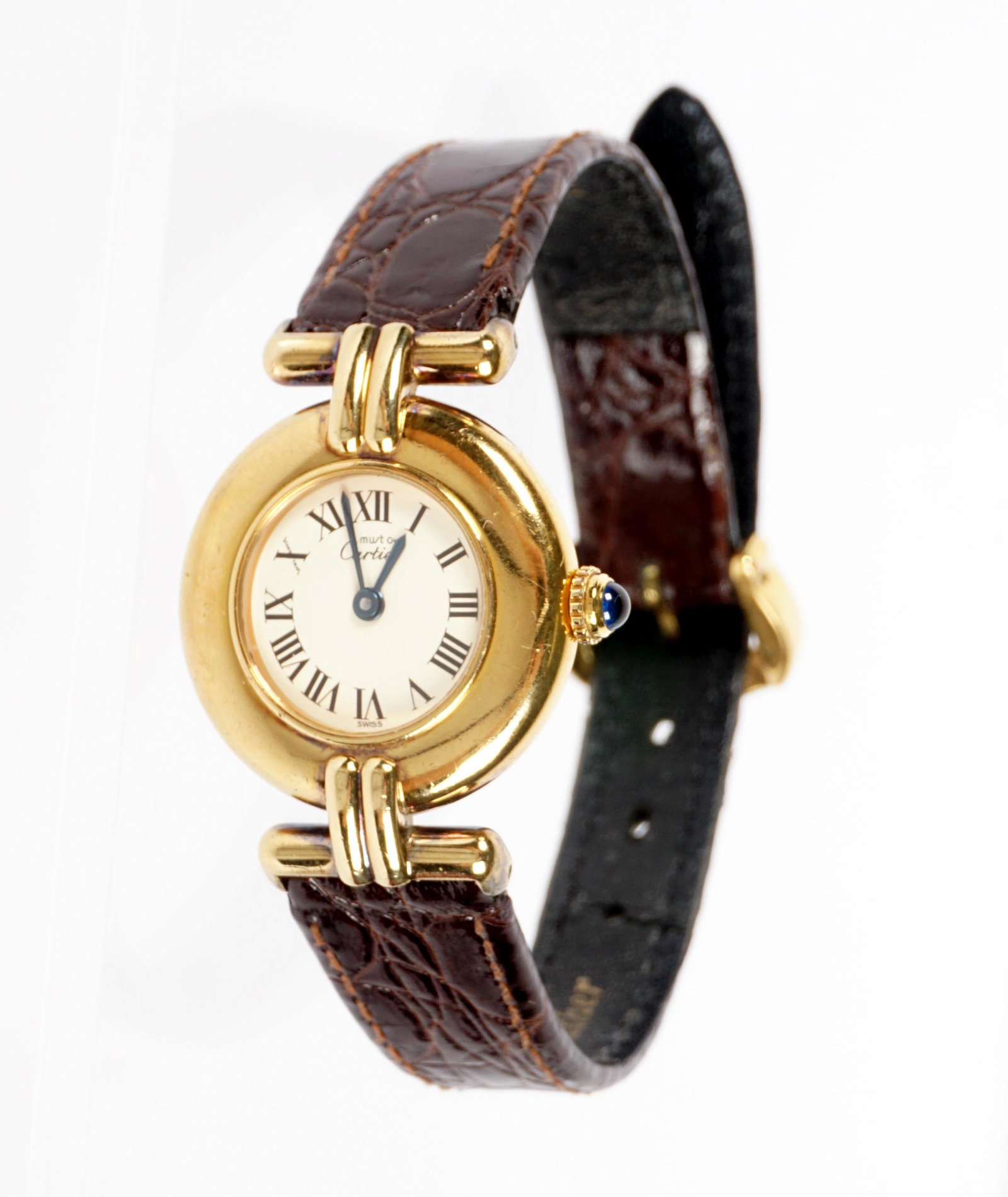 Must de Cartier Vermeil Sterling Ladies Watch: Round vermeil sterling case, marked on dial Must de Cartier, well marked on back, quartz movement, leather band. Case 7/8" dia, 7.75" long overall. Sold with Cartier box and bag. Condition: Wear to ba