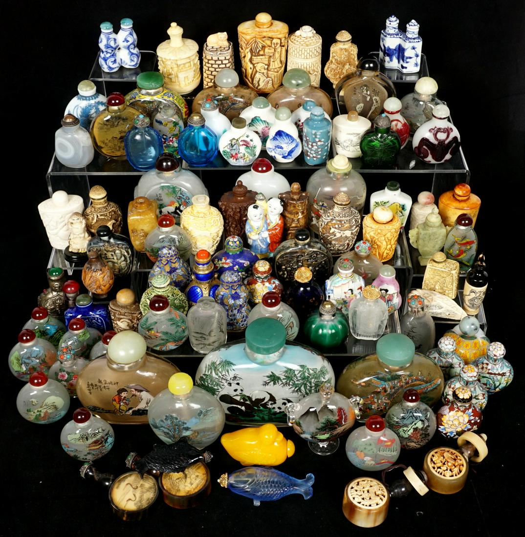 Collection of 102 Chinese Snuff Bottles: An assembled collection of approx. 102 pieces total comprising of inside painted, cloisonne, bone, porcelain, Peking glass, stone, and composite. Ages vary. Condition: Several missing tops and or spoo