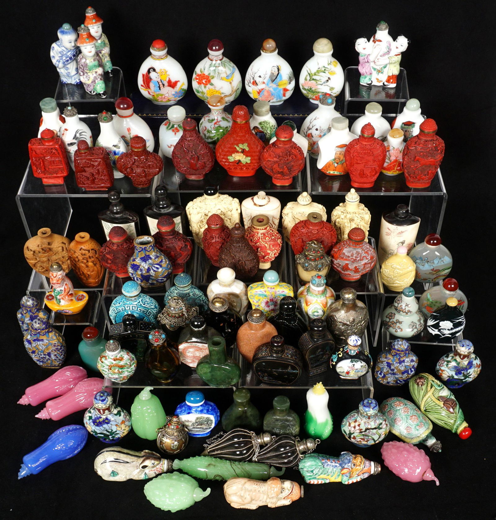 Collection of 99 Chinese Snuff Bottles: An assembled collection of approx. 99 pieces total comprising of porcelain, cinnabar, resin, glass, wood, mother of pearl, bone, metal and composite. Condition: Several missing tops and/or spoons.