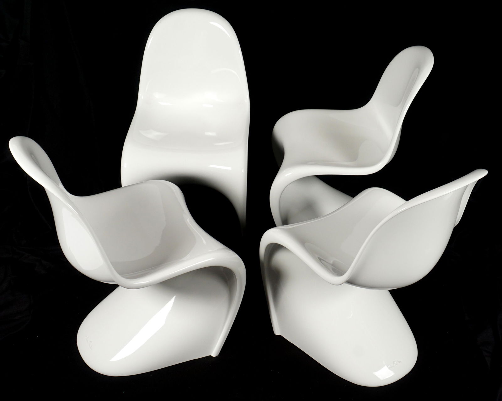 Set of Four White Verner Panton Chairs: Four white plastic injection molded chairs, signed on top of base Verner Panton, stamp marks under base, measure 33.25" h. x 19.5" x 22.5". Condition: Several with abrasions.