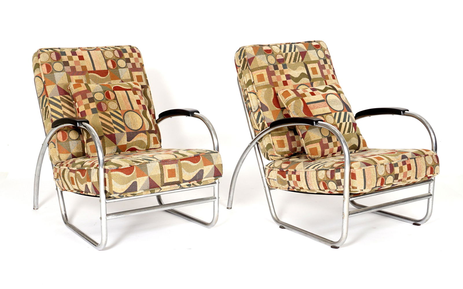 Manner of Kem Weber Royal Metal Deco Club Chairs: Style of Kem Weber, manufactured by Royal Metal, chrome tube, wood, and metal sheet frame construction. Patterned upholstery cushions, tags on metal seat base, overall 33" h. x 25.5" x 35" including c
