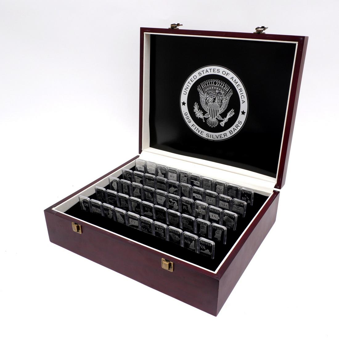 50 United States .999 Silver One Ounce Silver Bars: Collection of 50 individually slabbed one troy ounce silver bars, in hardwood display case with foam inserts. Box measures 5.25" h. x 1.25" x 14.5".