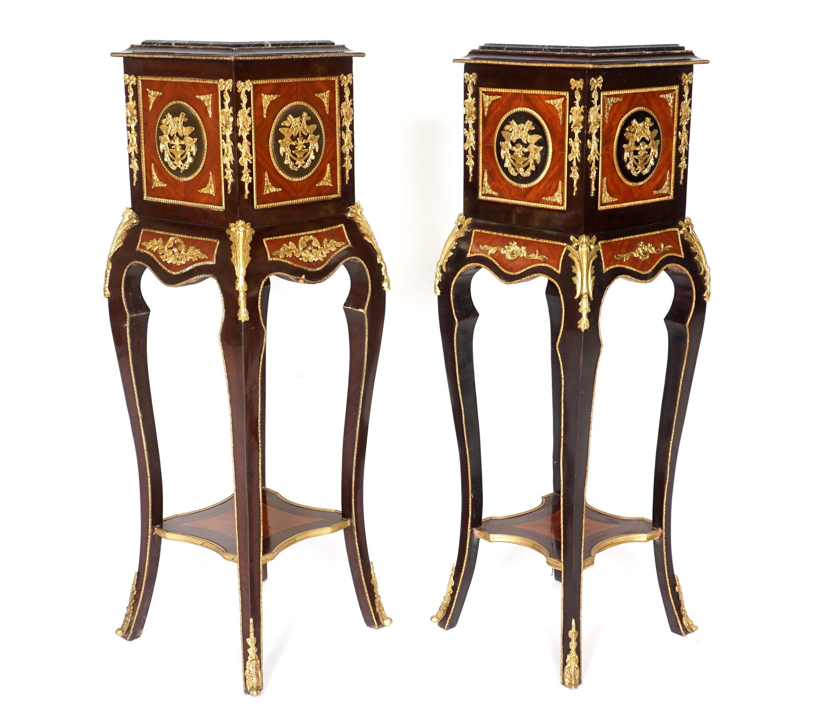 Pair Louis XV Style Marble Top Pedestals: Inset stepped marble top, mixed wood stand with applied gilt bronze accents, shapes skirt and legs, lower open shelf, overall 59.25" h. x 16" x 16". Condition: Veneer chips.