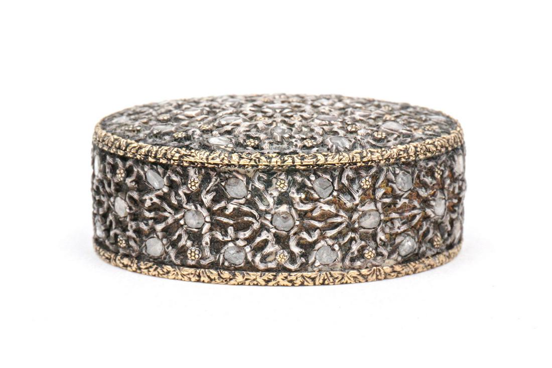 Buccellatti 18k Gold and Diamond Pill Box: Floral motif 18k white gold exterior with accent diamonds, vermeil interior, mirror inside lid, well marked "750 Made in Italy, M. Buccellatti, Murano, Roma, Firenze, New York, Palm Beach". 1.75 x 1.5