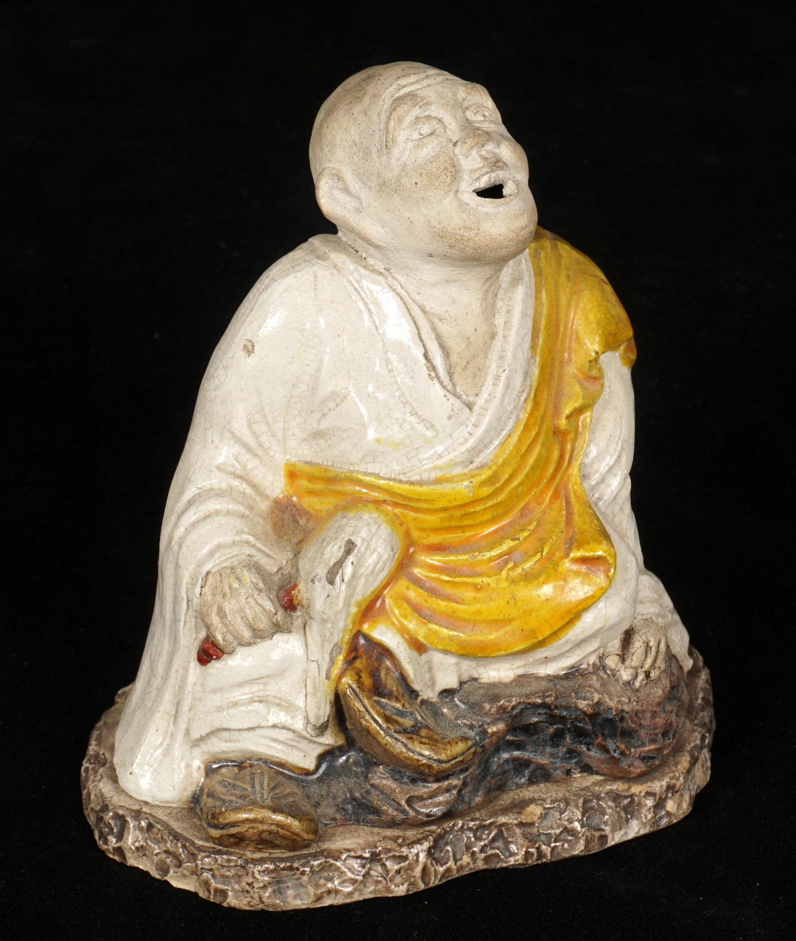 Chinese Porcelain Seated Elder Figure Censer: Figural seated elder or priest with fly whisk, yellow and white glaze, removes from base, unmarked, overall measures 4" h. x 3.75". Glaze flaws and minor chips.
