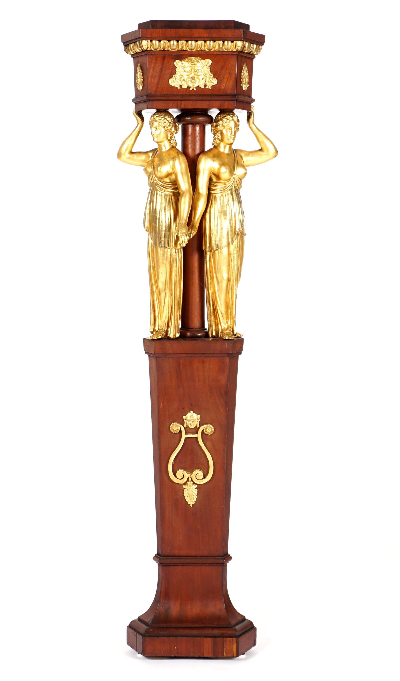 19th C French/Russian Parcel Gilt Figural Pedestal: Stepped triangle top with canted corners over egg and dart gilt trim, applied gilt wood masqueron and foliate fans. Two full figural gilt wood maidens supports, conforming trunk with applied gilt wood