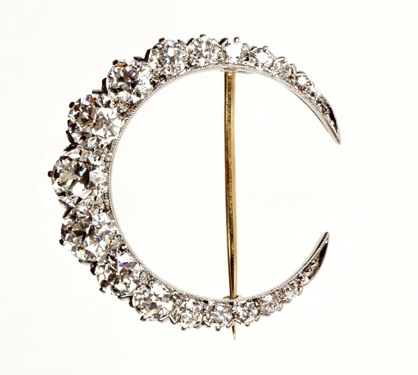 Tiffany & Co. Gold & Diamond Crescent Brooch: Crescent form brooch / pin, white gold, approx. 3.65 ctw of diamonds, G-H in color, largest center stone approx. .75ct. Stamped Tiffany & Co., 1 1/8" dia. Approx. 7 grams inclusive of stones. Conditio