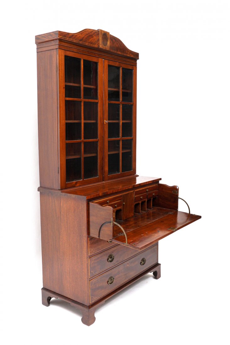 American Hepplewhite Secretary Bookcase: Circa 1840-1860, mahogany case with string inlay, shaped crest over two six light glass doors, three shelves. Top secretary door, fitted interior with center prospect door, drawers, valenced pigeon ho