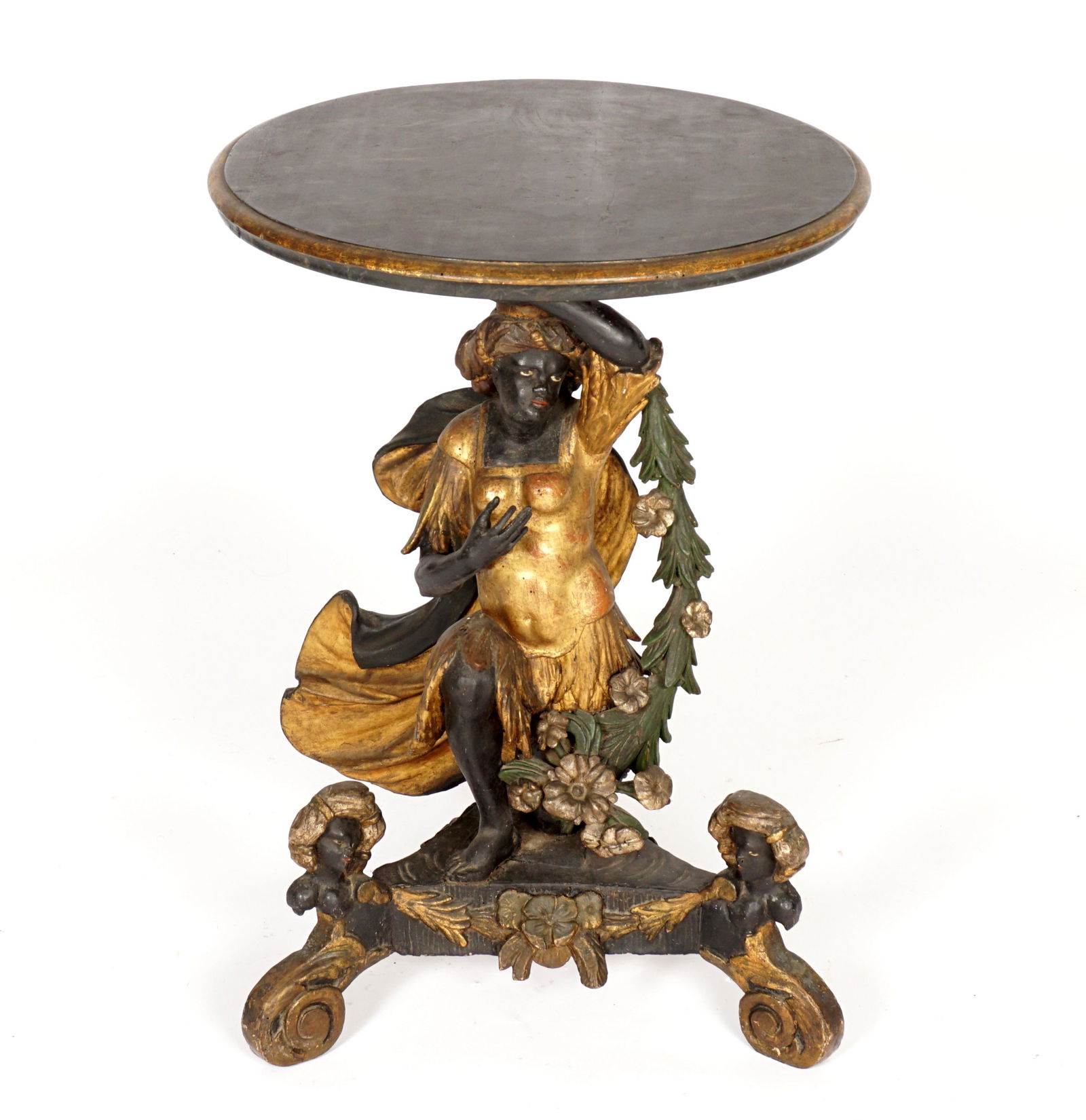 Antique Italian / Venetian Blackmoor Center Table: Ebonized and gilt decorated, round top over figural female blackamoor support with foliate garland and flowing robe, splayed base, blackamoor masquerons over three scroll feet. Overall 34" h. x 24.25"