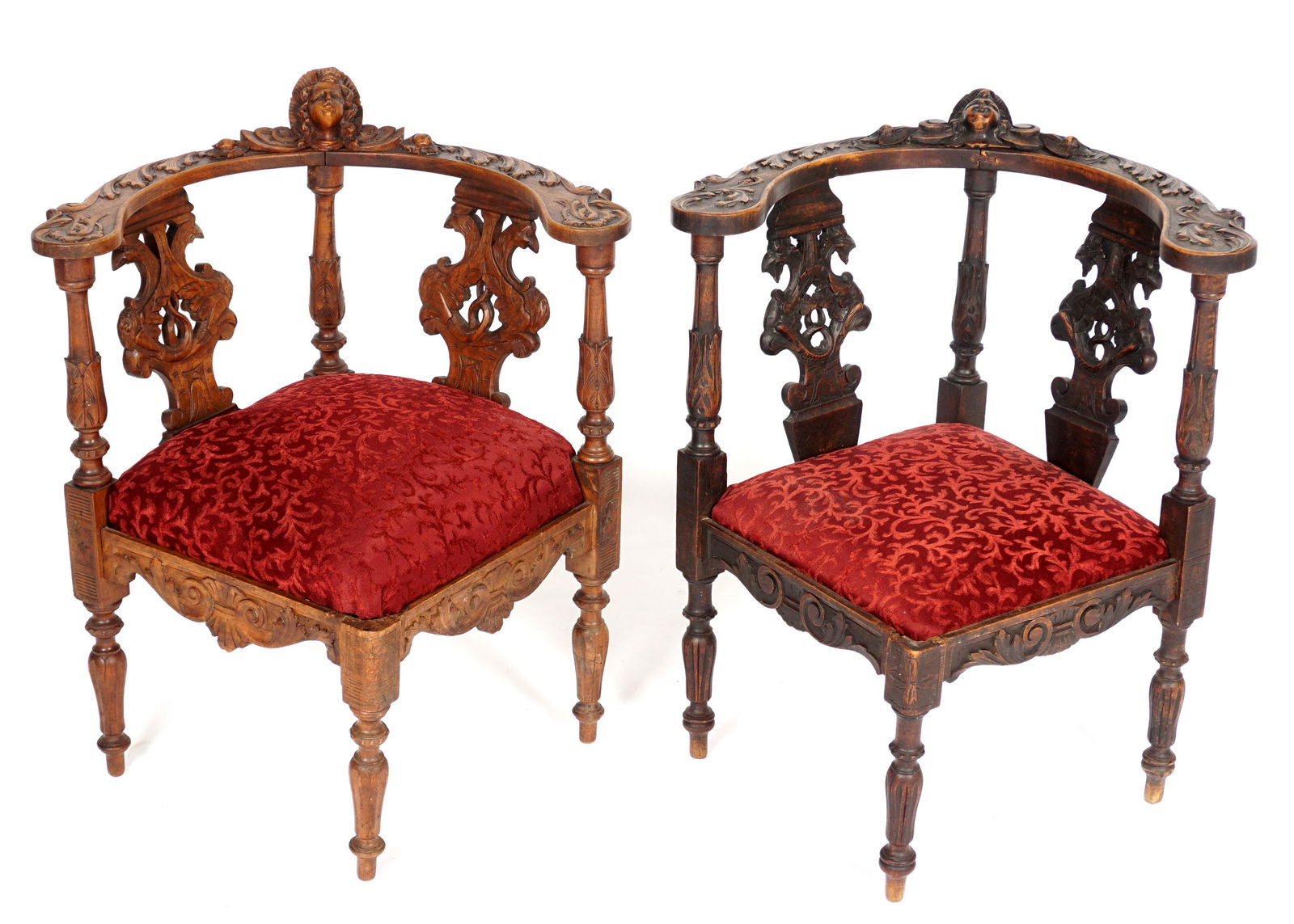 19th Century Pair Italian Carved Corner Chairs: Similar, but not identical, pair Renaissance Revival corner chairs, curved top rail carved with angel and foliate scroll, figural griffin back splats, acanthus leaf supports. Foliate scroll apron over