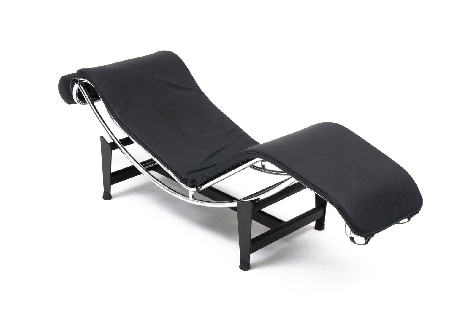 Le Corbusier Chaise Lounge Chair: Chrome tubular steel frame, black leather cushion and pillow, black powder coated base, overall measures 23" h. x 66" x 23" on base. Condition: Wear consistent with age and everyday use.