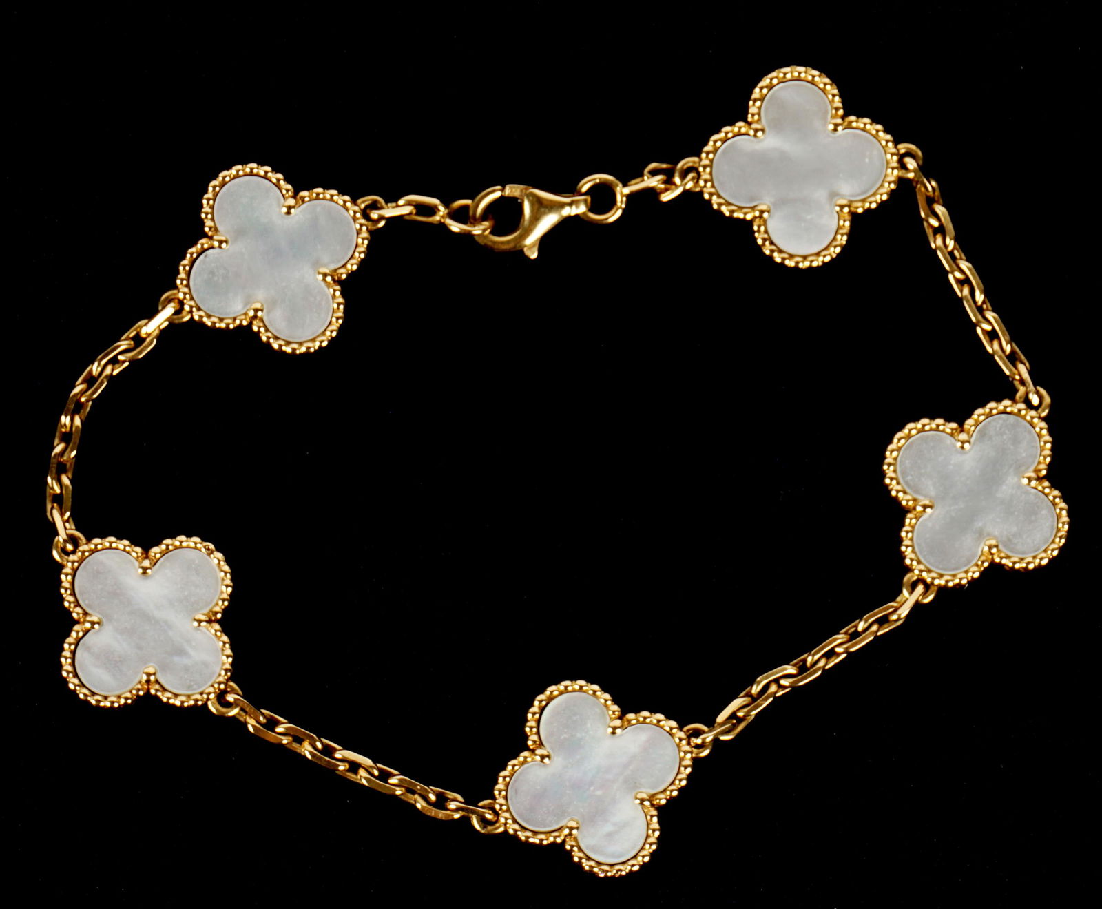 Van Cleef & Arpels 18k MOP Clover Leaf Bracelet: 18k yellow gold bracelet, fixe mother of pearl clovers, well marked VCA 750 and serial number on sides of clover, 7.5" long total.