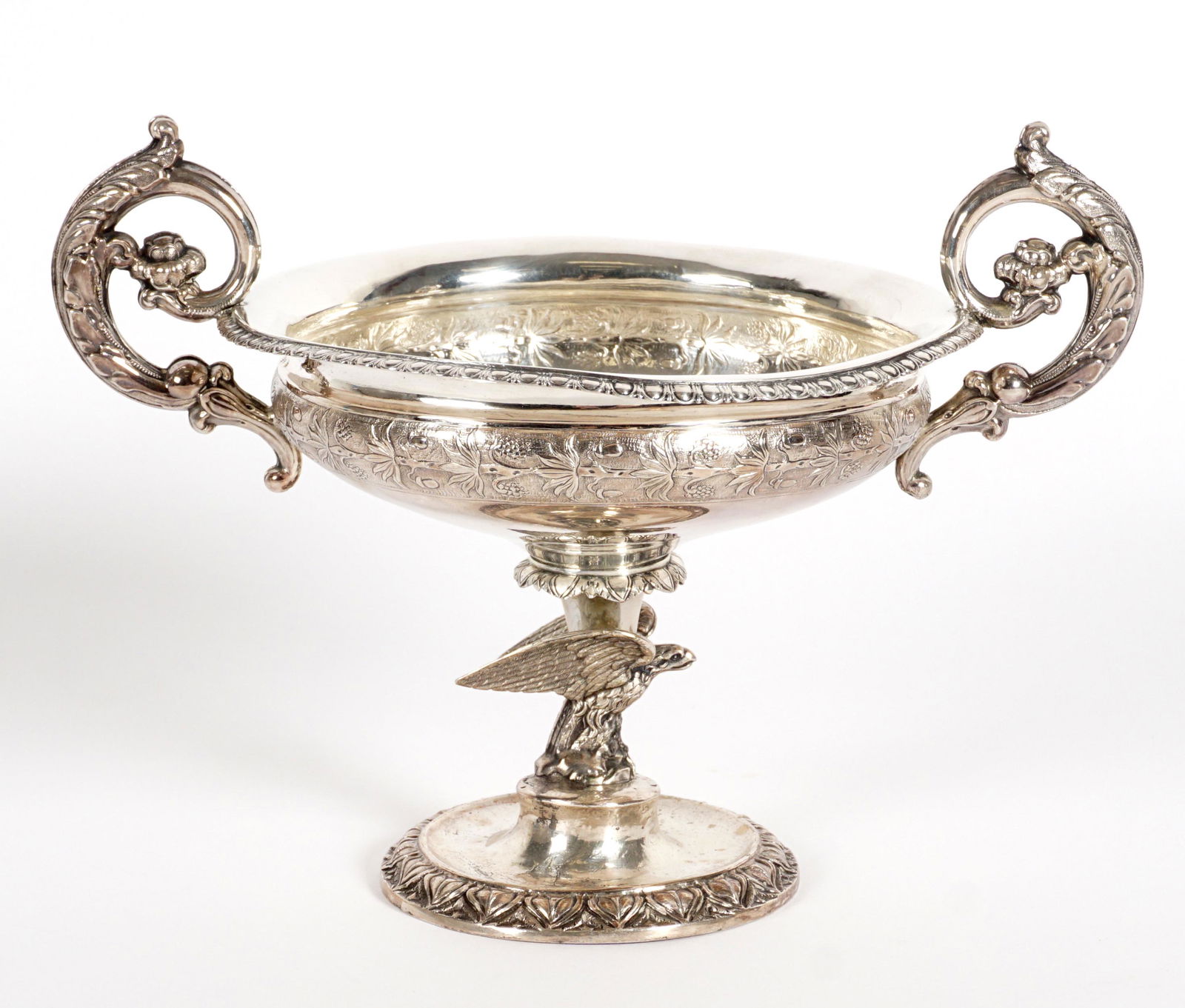 1842 Danish Silver Figural Eagle Compote: Hallmarked with 1842 Peter Hinnerup assay mark, foliate scroll handles, embossed fruiting trees band outside bowl, full figural eagle over foot, overall 6.25" h. x 8.75" dia. Approx. 6.6 troy oz. Cond