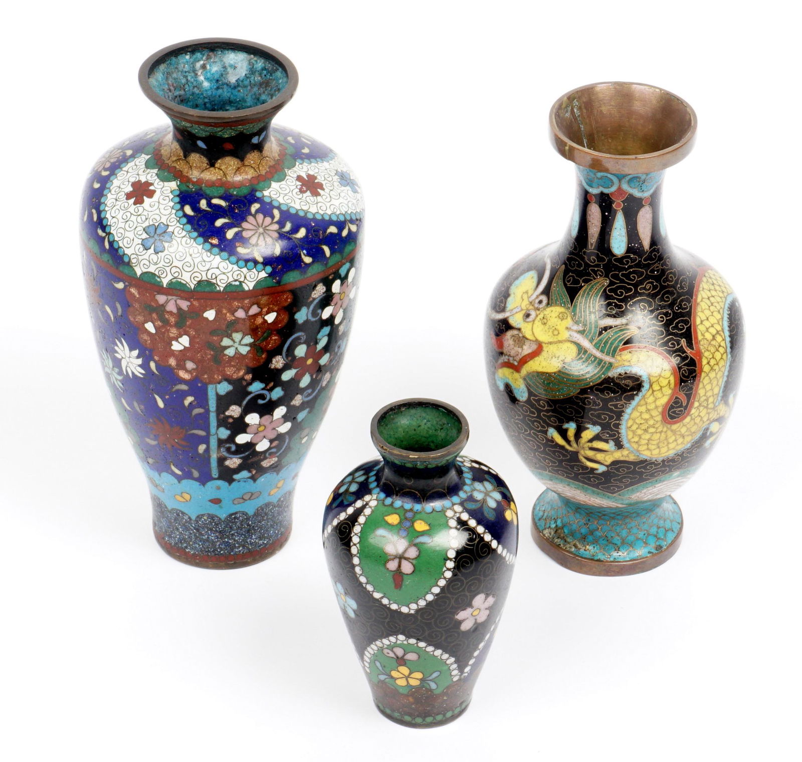 Three Chinese Cloisonne Vases: An assembled collection of three pieces total to include 1) Blue and black ground with floral and butterflies decoration. 6" h. x 3.25". 2) Black ground with dragon over waves motif, 5.5" h. x 3". 3)