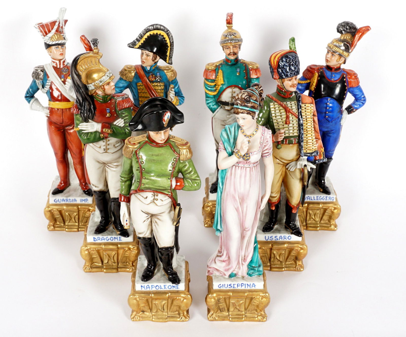 8 Piece Capodimonte Porcelain Soldier Figurines: Eight pieces total each marked Cortese and Capodimonte mark, to include Napoleone, Guardia Imp., Ussaro, Mareciallo, Dragone, Cavalleggero, Lanciere, Guiseppina. Tallest measures 10.75" h.. Condition: