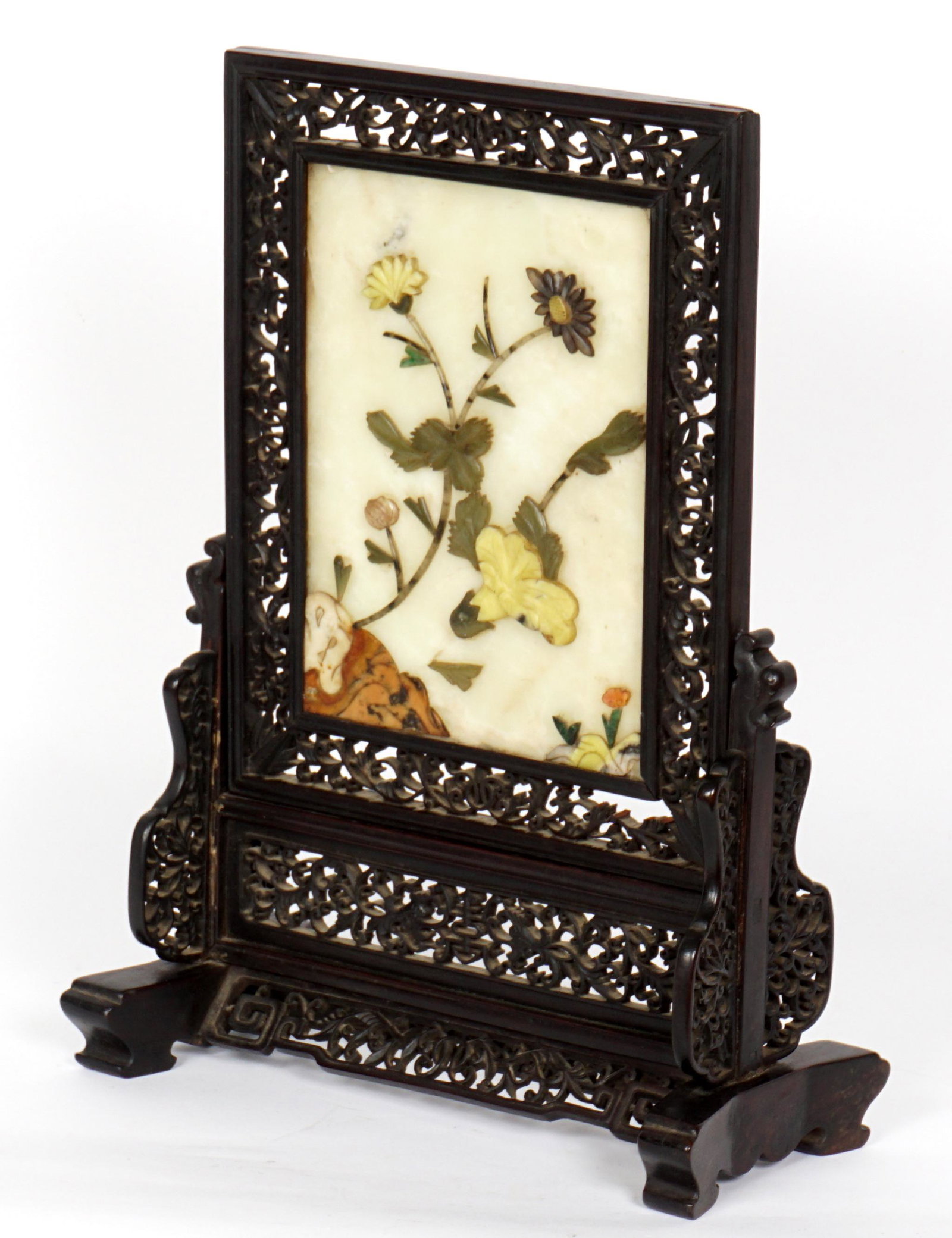 19th Century Chinese Carved Stone Table Screen: Translucent stone ground with assorted stone floral decoration, detailed reticulated pierced carved frame and stand. Stone table measures 8.75" x 6.5". overall on stand 16.25" h. x 12" x 5.5". Conditi