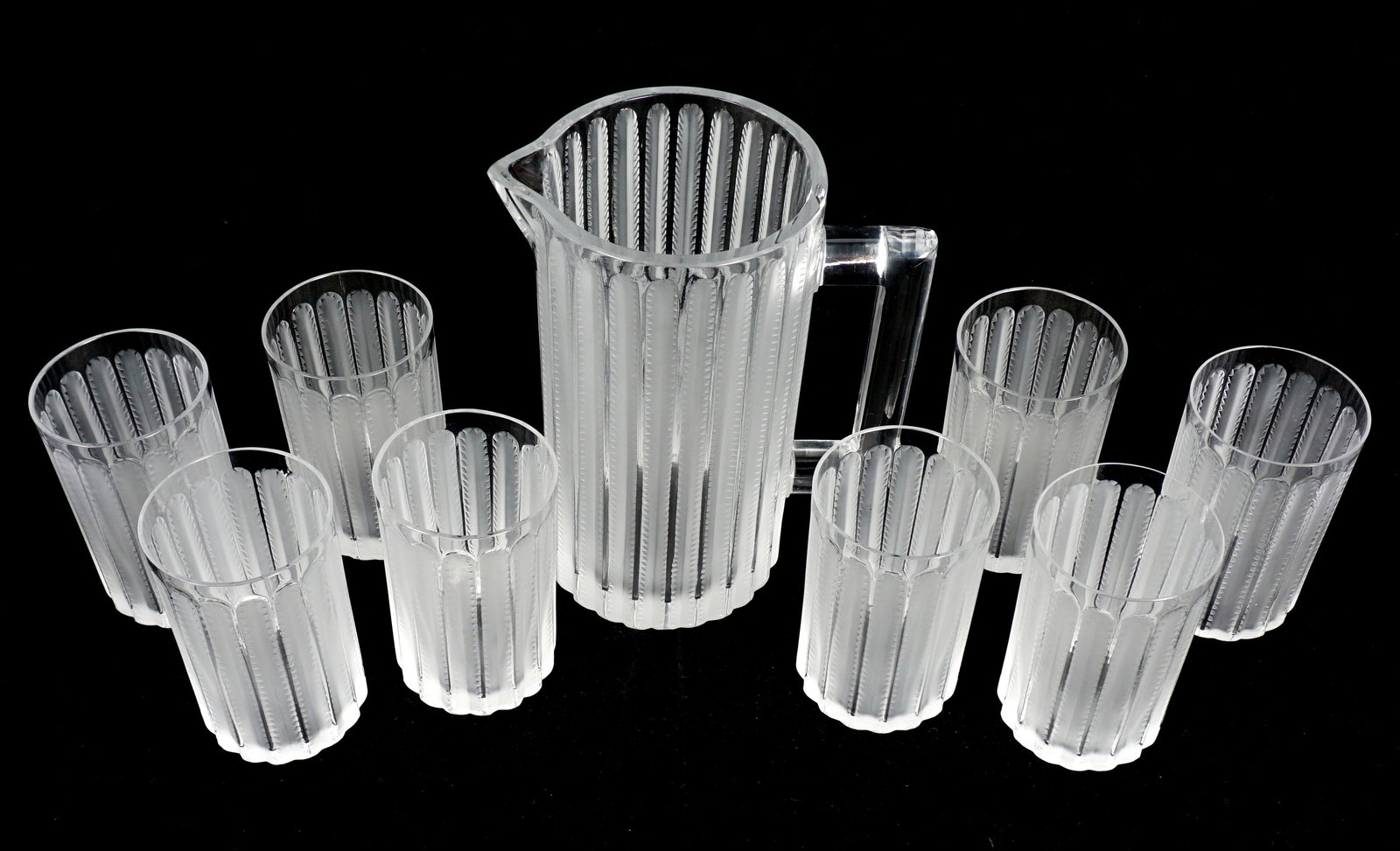 Nine Piece Lalique Crystal Jaffa Lemonade Set: Nine pieces total in the Jaffa pattern by Lalique to include a lemonade pitcher 9" h. x 7.5", eight tumblers 5" h. x 3" dia. Each signed Lalique, France.