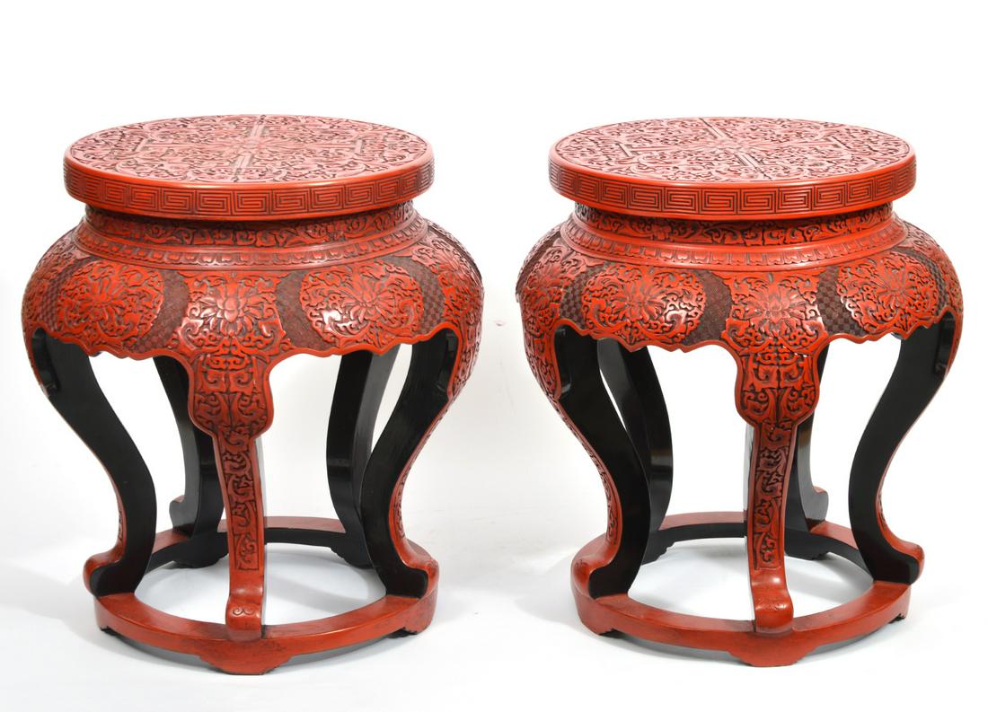 Pair Chinese Cinnabar Red Lacquer Garden Stools: Profusely carved all over with foliate motifs, shaped apron and legs, circular base, overall 18\" x 15.5\".
