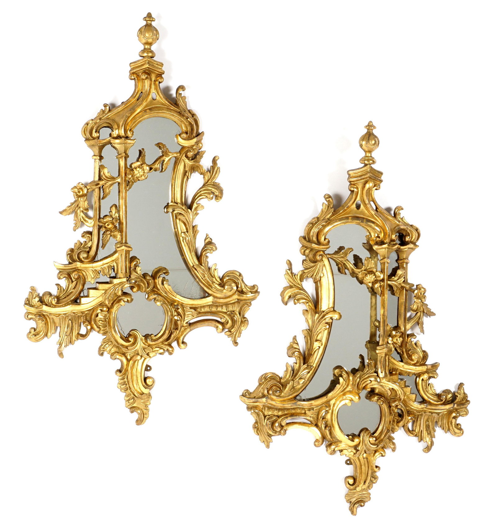 Pair Italian Chinese Chippendale Gilt Wood Mirrors: 18th / 19th Century foliate scroll with floral garland carved gilt wood frames, conforming mirrors, overall 45.25" h. x 27" x 3.75". Condition: Minor chips and repairs.