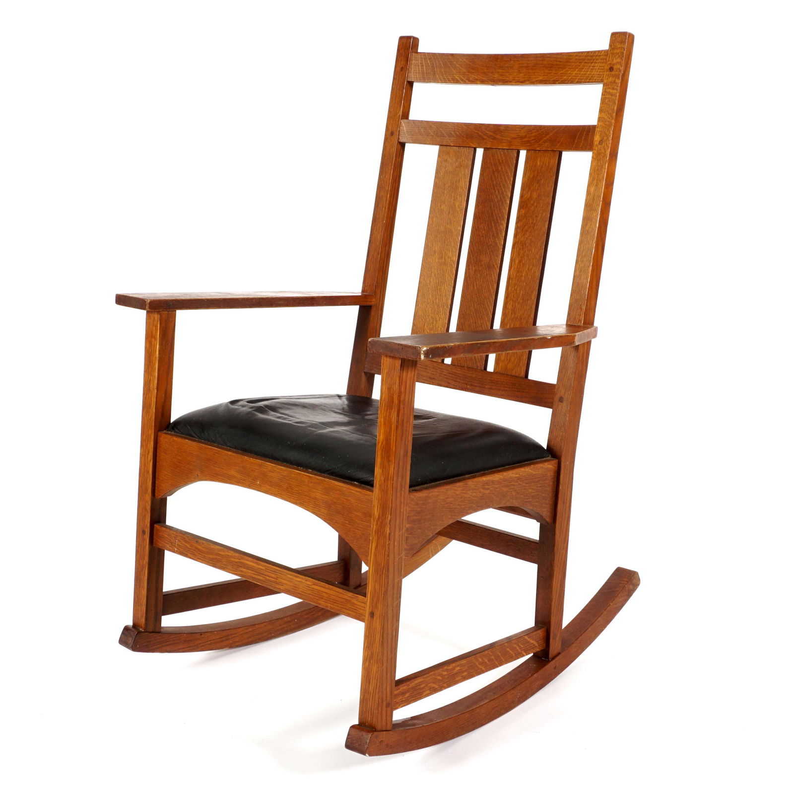 Stickley Furniture Oak Rocking Chair: Oak rocker, triple splat back, black leather seat, overall 41.5" h. x 26" x 31". Condition: Seat in need of re-upholstery, other wear consistent with age and use.