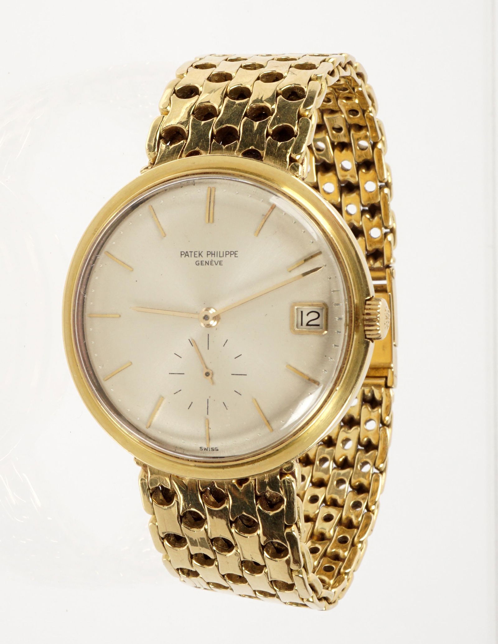 Vintage 18K Patek Philippe Calatrava Wrist Watch: 18k yellow gold 34mm case, caliber 27-460M, serial number 1,121,xxx, circa early 1970's, silvered dial. Later 18k reticulated yellow gold bracelet has been soldered to the case itself, bracelet length