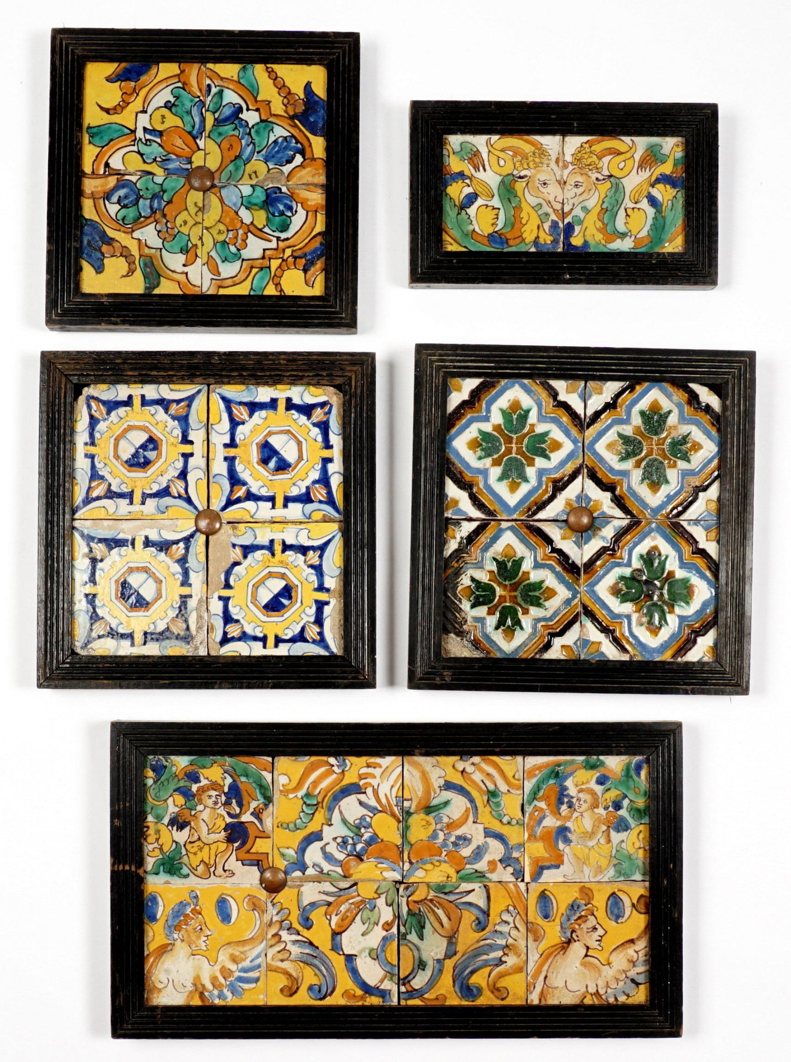 Five Framed Antique Spanish Tile Plaques: An assembled collection of five frames, one with eight tiles, three with four tiles, one with two tiles. Varying polychrome designs including floral, figures, mythological creatures, and geometric sha