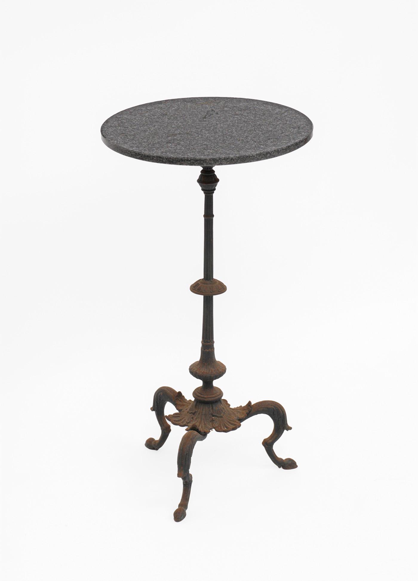 Grand Tour Cast Iron Marble Top Side Table: Round mottled black and grey marble top over cast iron fluted shaft post, foliate base, three splayed legs. Overall 32" h .x 17" top dia. Condition: Surface rust.