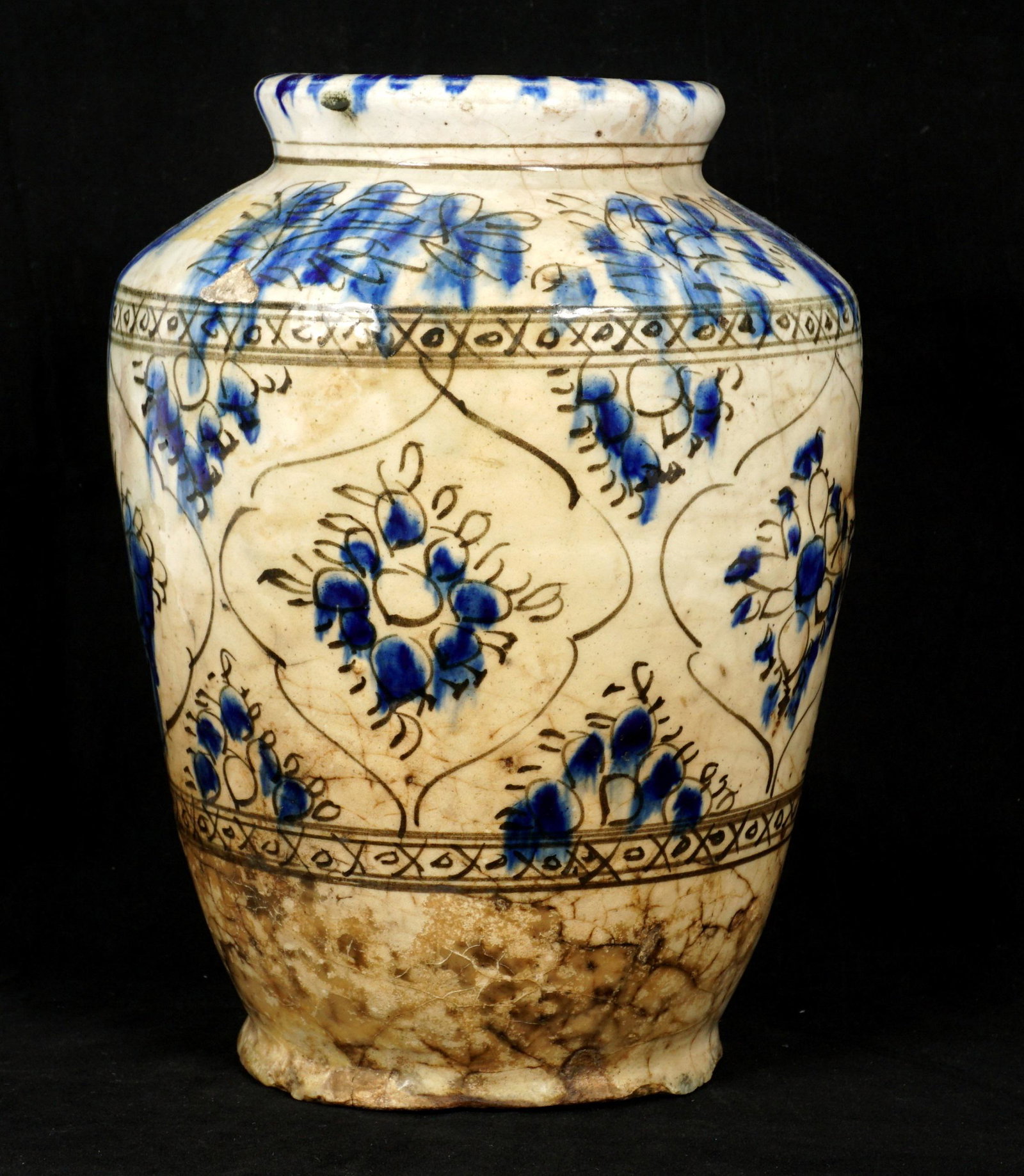 17th-18th C. Safavid Blue & White Pottery Jar: Cream ground with blue floral sprays and geometric bands. Overall 9.75" h. x 7" dia. Condition: Glaze ships, cracks.