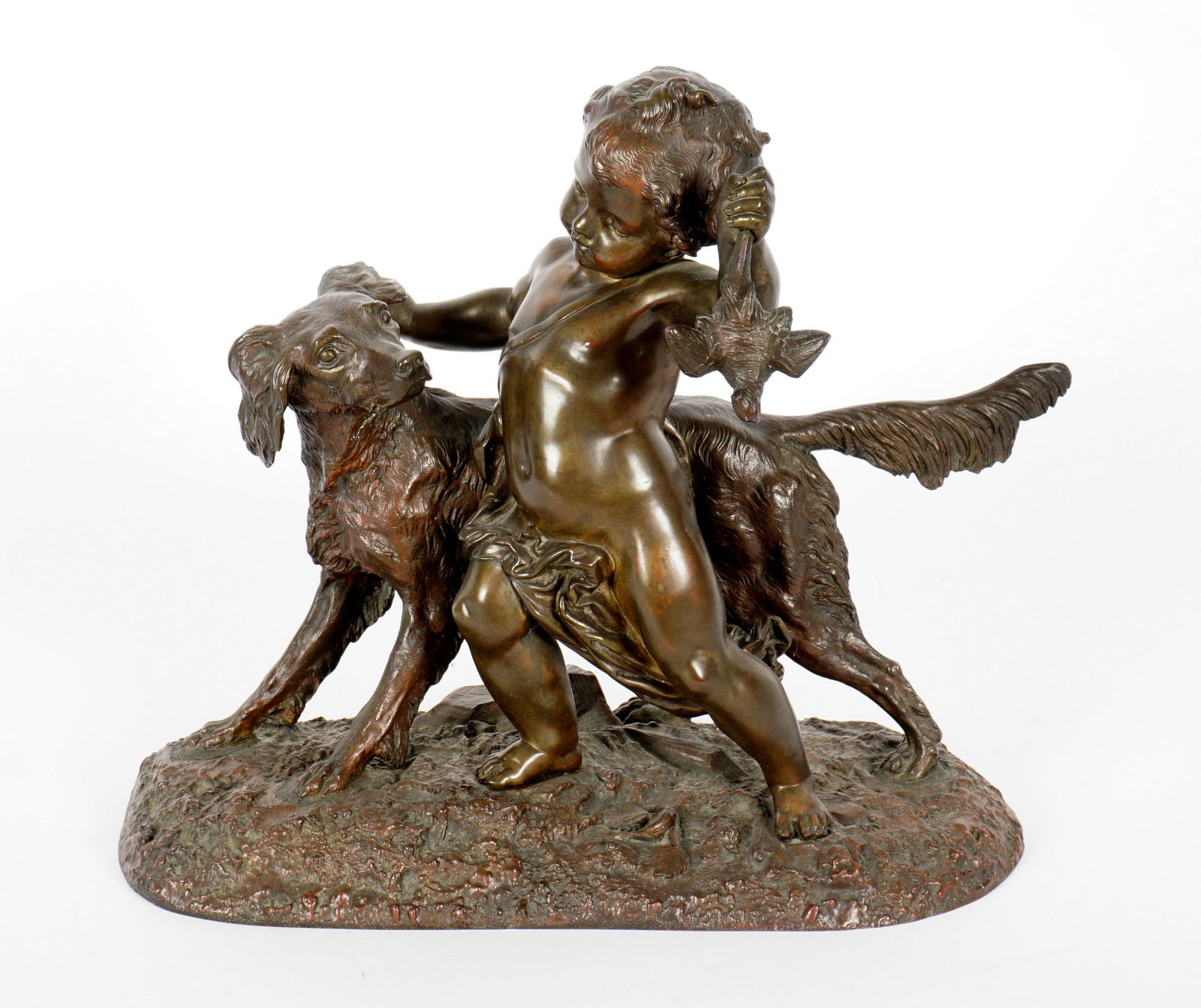 Bronze Sculpture of Putti with Dog: Patinated bronze figural group of a putti holding a captured bird in one hand and his hunting dog, no visible signature or foundry mark, 11" x 12.5" x 5.5".