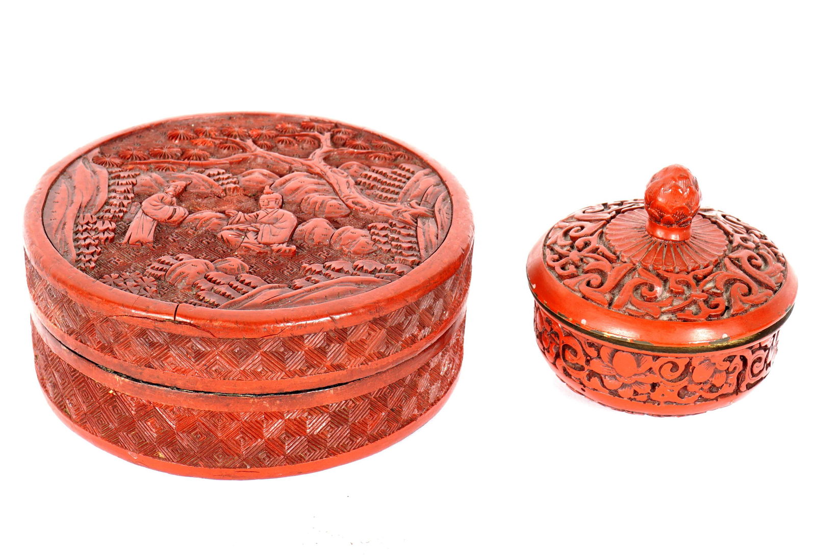 Two Chinese Cinnabar Red Lacquer Boxes: Two pieces total to include 1) Round covered box, figures in landscape lid, geometric sides, black lacquer interior. 2.25" h .x 5" dia. Chips, losses, repairs. 2) Round covered box, artichoke finial o