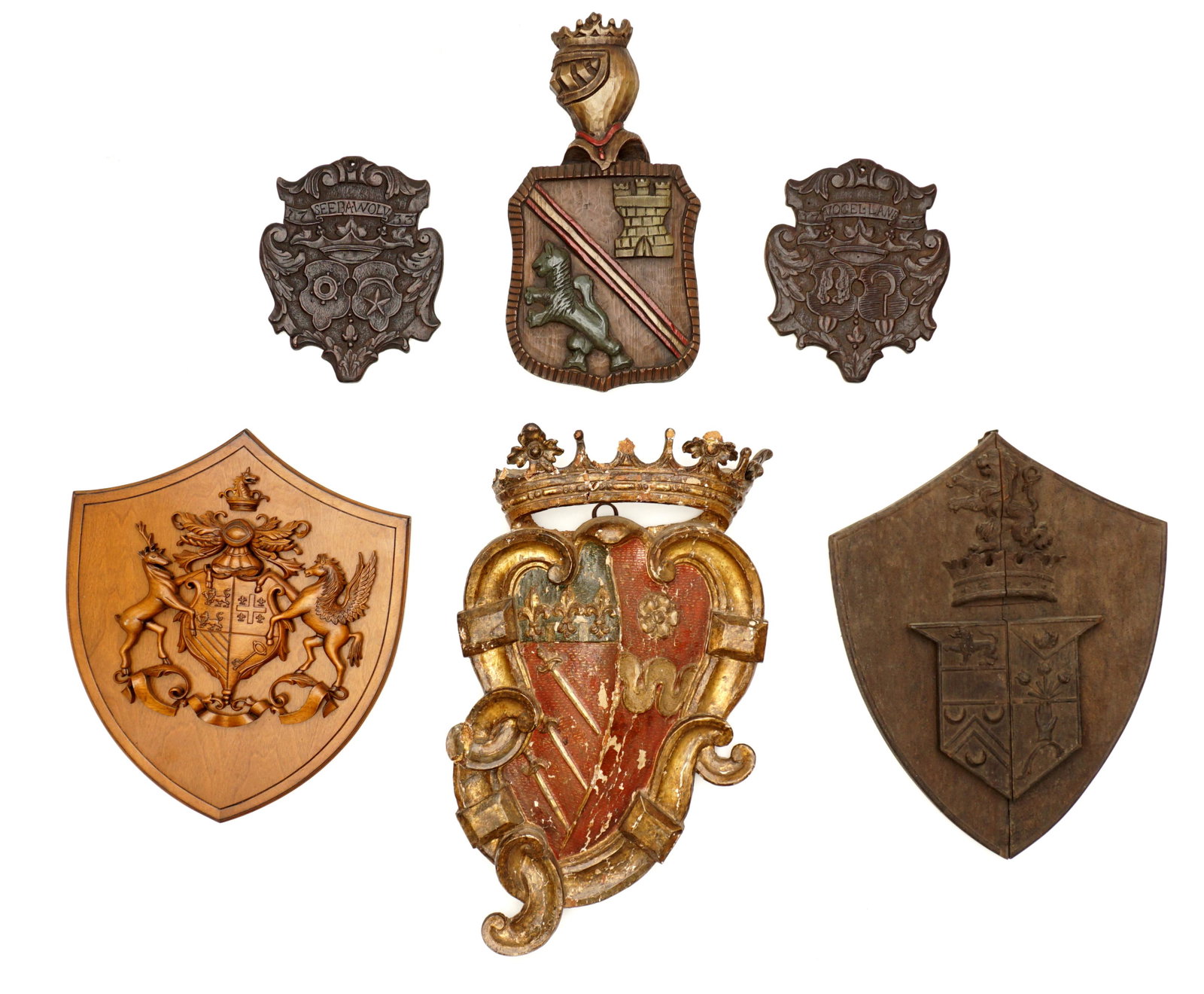 Collection of 6 Antique Coat of Arms Wall Plaques: An assembled collection of 6 coat of arms and heraldic shields total, various patterns and designs. Largest polychrome paint and gilt decoration, crown over shied, measures 28" h. x 17". Condition: La