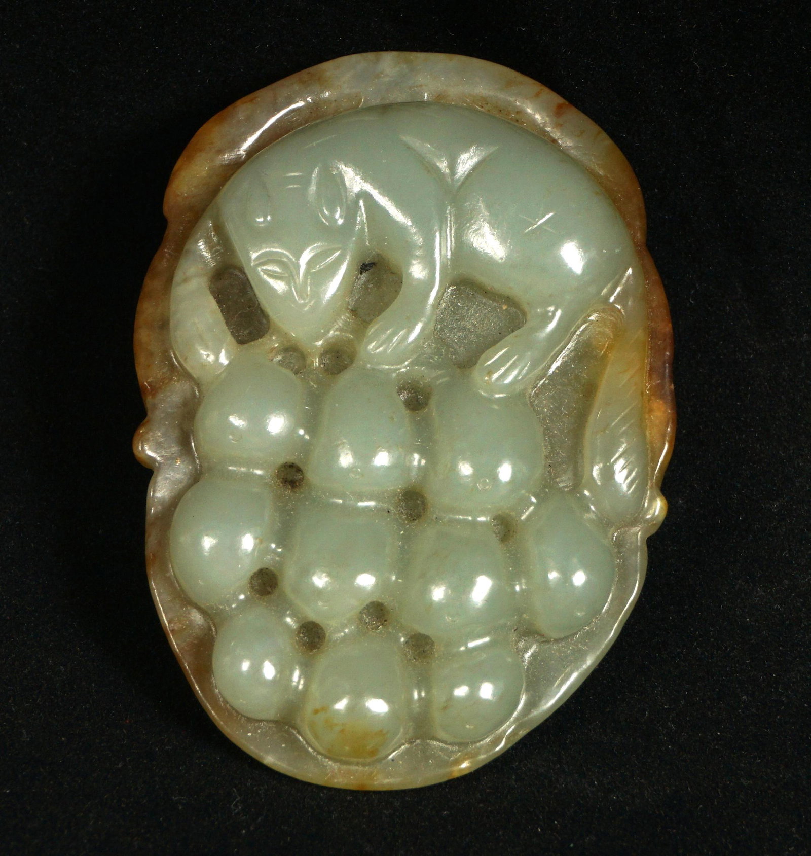 Chinese Carved Jade Fox with Fruit: Celadon and russet jade, carved figural fox above fruit, overall 2.5" x 1.75".