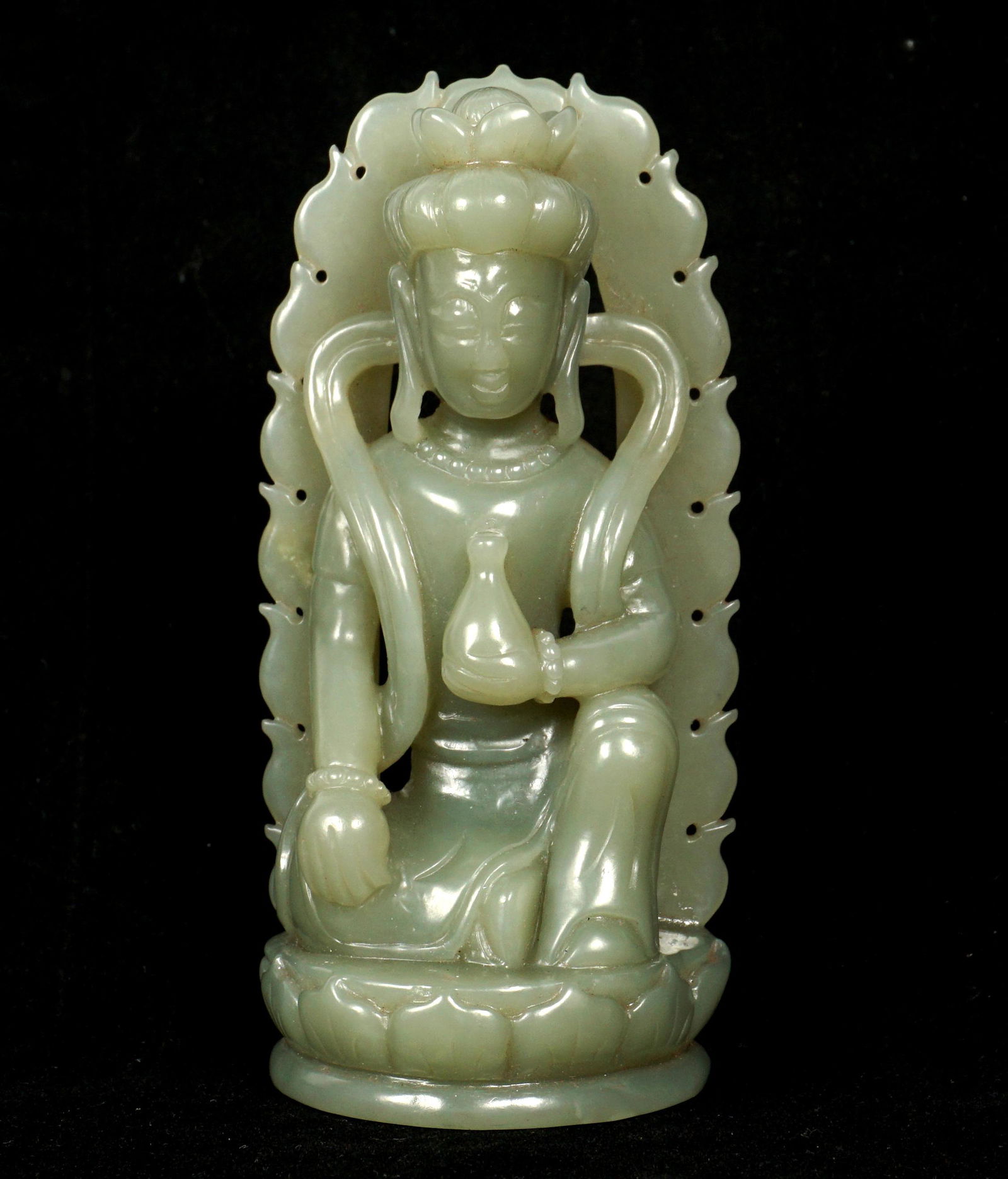 Chinese Carved Jade Figural Guanyin: Figure of a seated Guanyin on lotus blossom, holding a gourd in one hand, 4.25" h .x 2" x 1.25". Sold with fitted wood stand.
